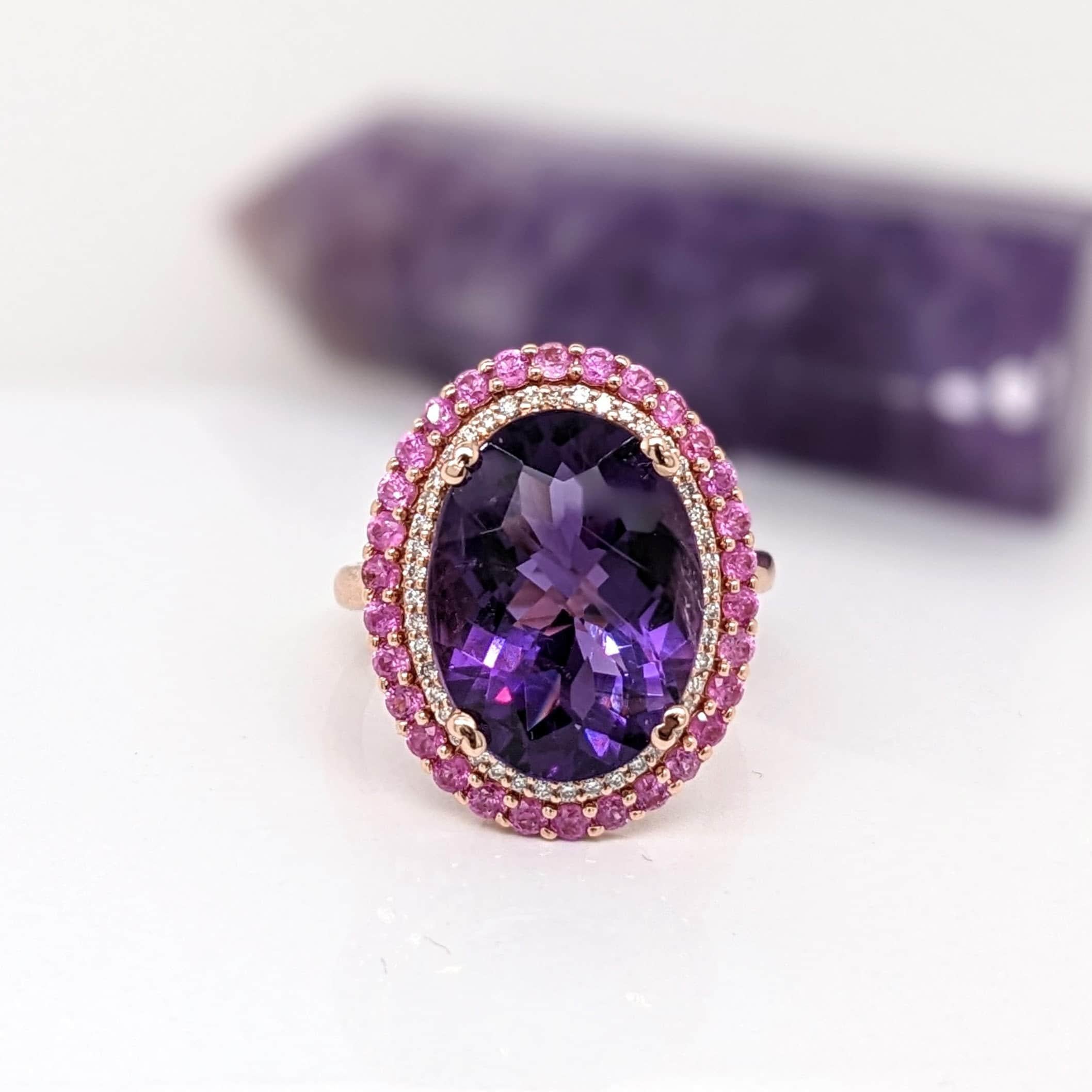 This beautiful ring features a stunning vibrant deep purple amethyst in 14K rose gold with pink sapphire and diamond accents. This statement piece makes for a stunning accessory to any look!

A fancy ring design perfect for an eye catching