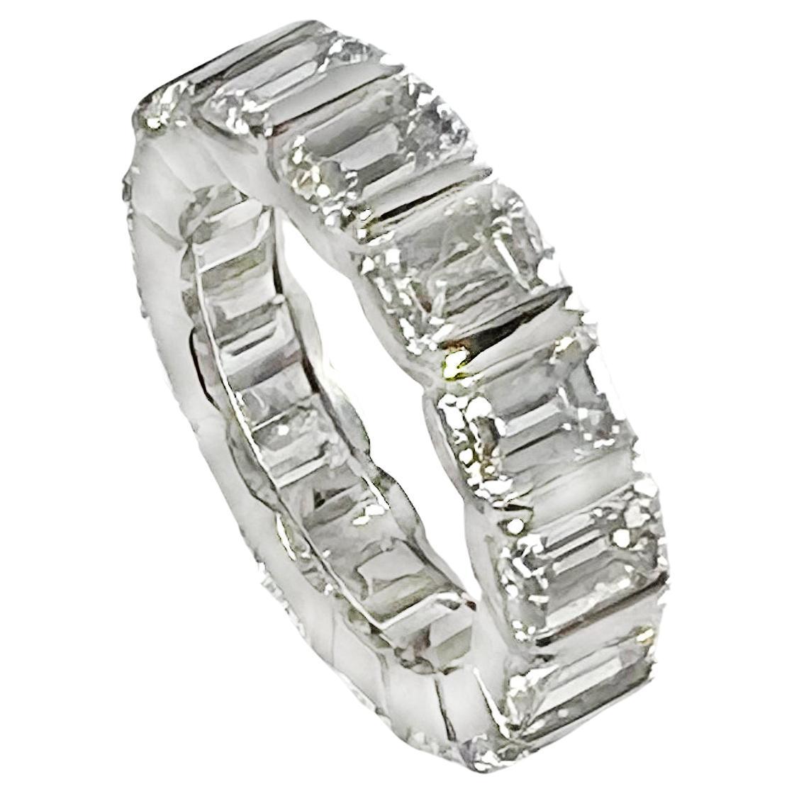 Platinum eternity band ring, showcasing fifteen emerald-cut natural diamonds weighing approximately 7.72 total carats.  The diamonds are all F-G color and VS1-VS2 clarity weighing approximately 0.50-0.51 carats each.  Polished channel-set platinum