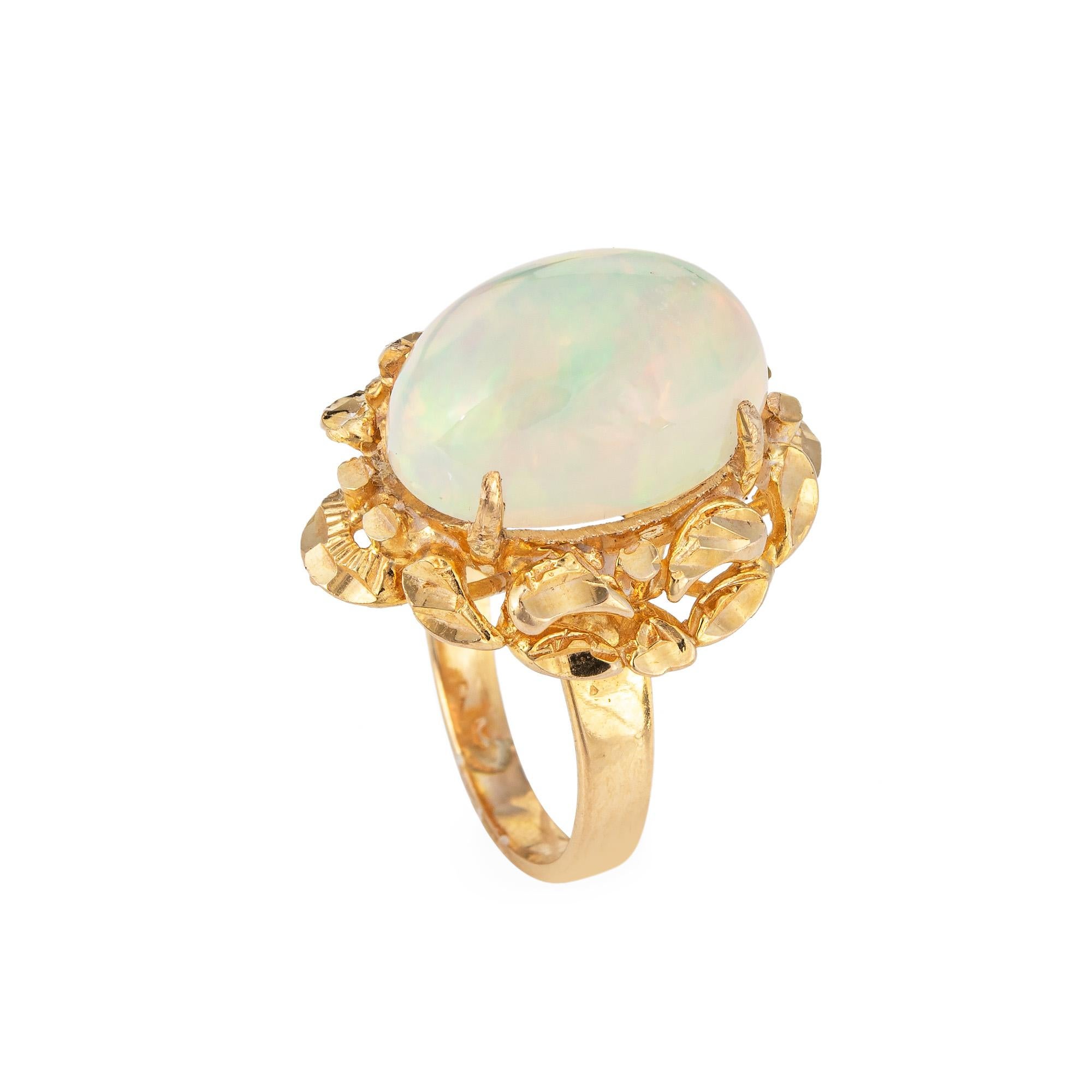 Stylish vintage opal cocktail ring (circa 1970s) crafted in 14 karat yellow gold. 

Cabochon cut opal measures 15.5mm x 11.5mm (estimated at 7 carats). The opal is in very good condition and free of cracks or chips. 

The natural Ethiopian opal is