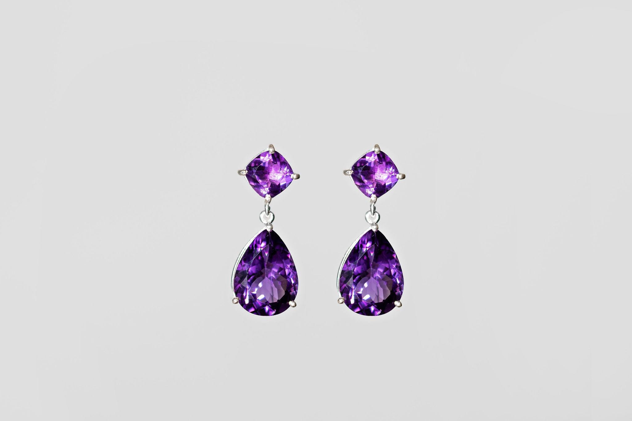 Elevate your style with these glamorous drop earrings. Handmade using recycled sterling silver and Purple Amethysts. The pear-shaped stone is 6 carats, and the square top stone is 1ct. They are exceptionally well cut and crafted using upcycled