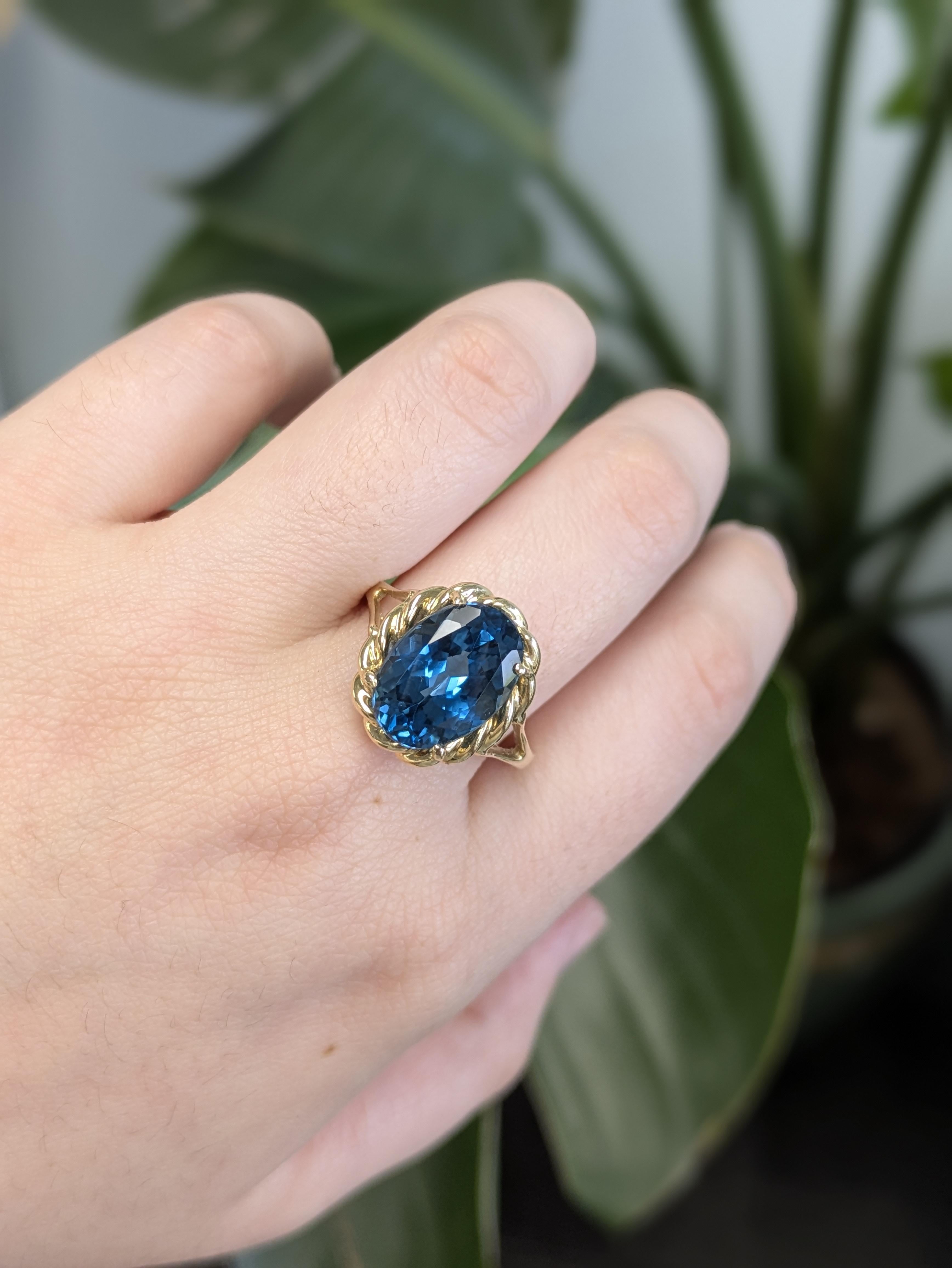 A stunning solitaire estate ring featuring an oval London blue topaz set in 14k solid yellow gold. Its classic design highlights the deep, captivating blue of the topaz for timeless elegance.

