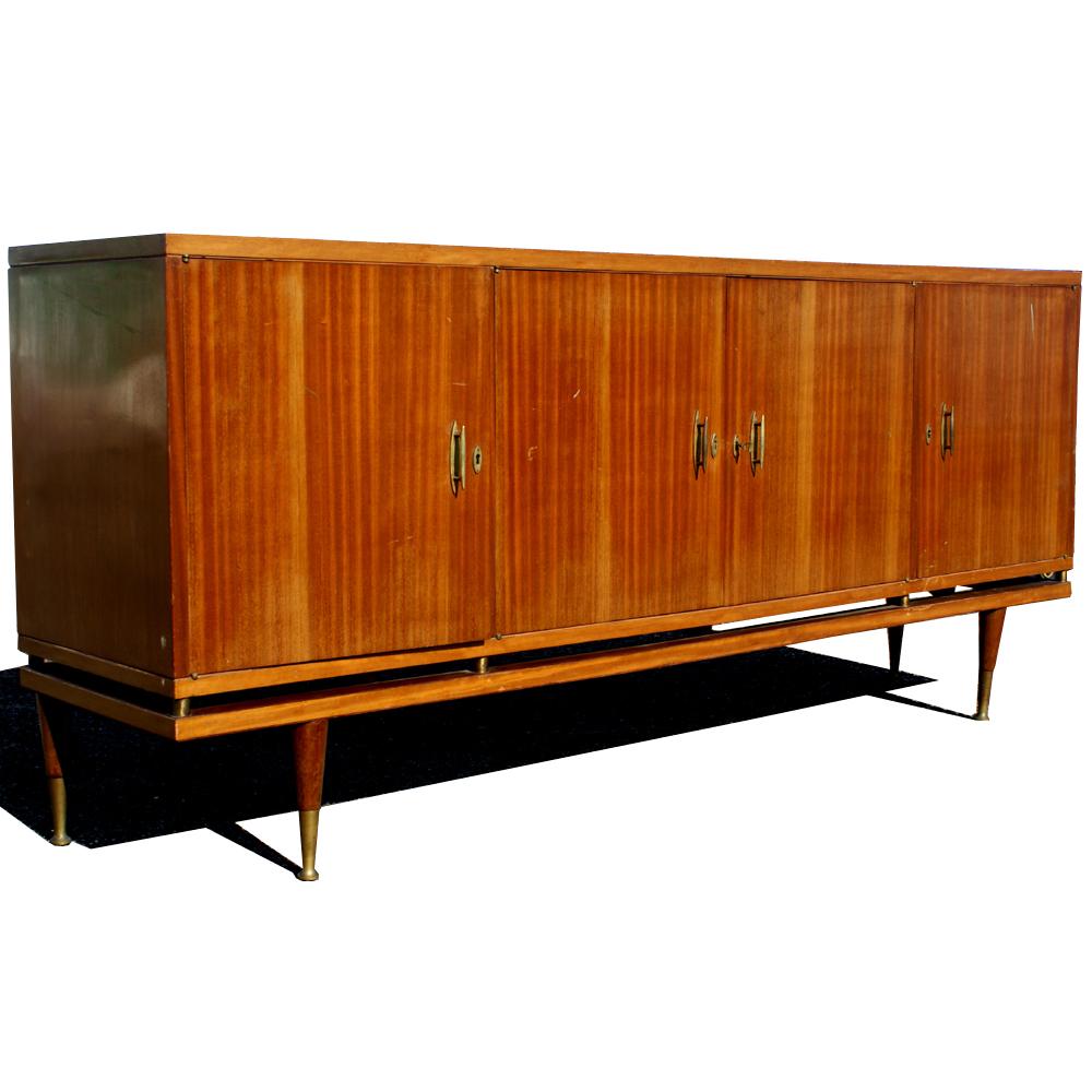 A stunning mid century modern buffet or credenza of Italian design.  Four doors concealing shelved storage and two drawers.
Age apprpriate wear.