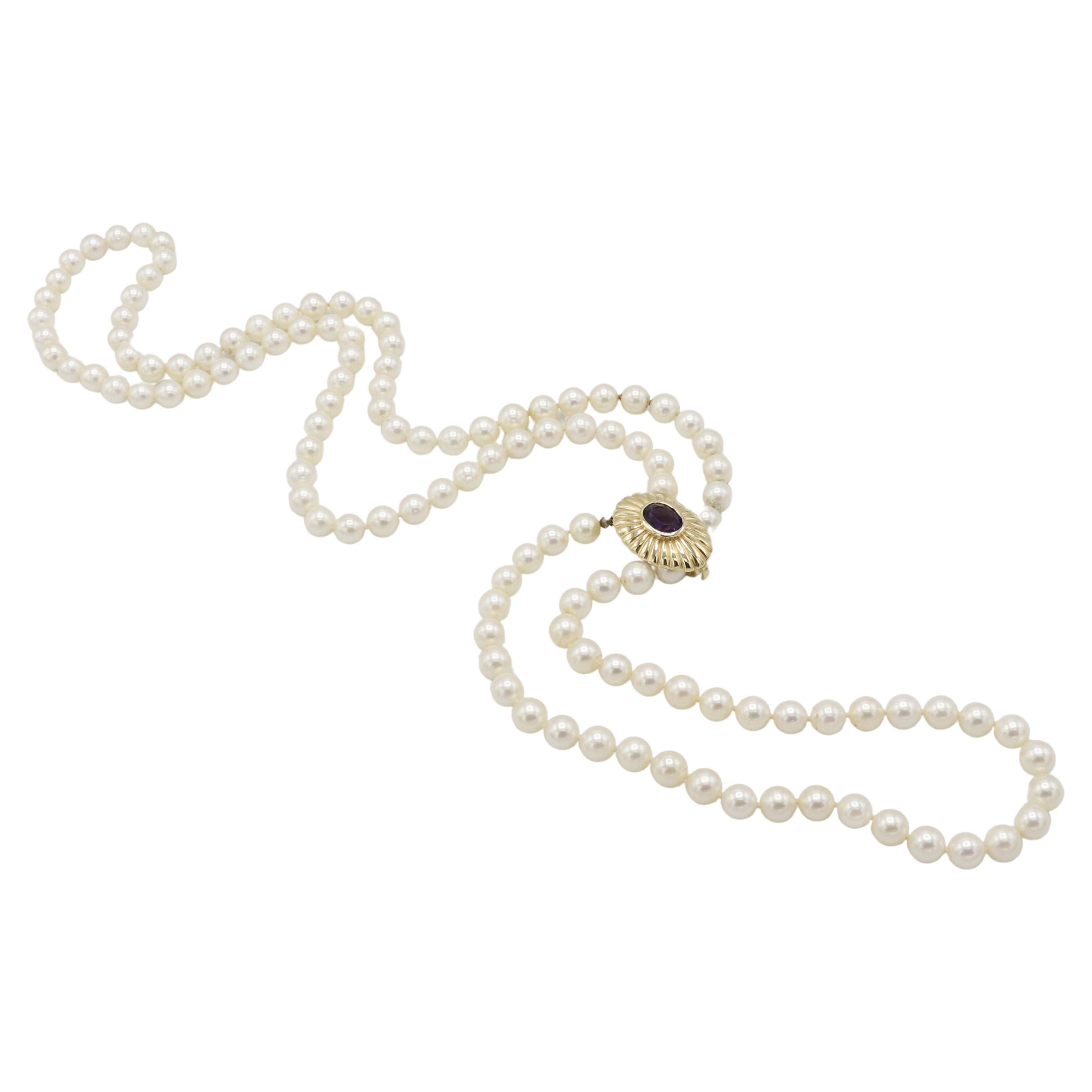 7mm Cultured Pearl Necklace with Adjustable 14 Karat Yellow Gold and Amethyst Stone Clasp 

Metal: 14k yellow gold
Weight: 60 grams
Length 34 inches
Pearls: 7mm cultured white pearls with creamy luster
Clasp: 23 x 17mm
Gemstone: Amethyst
