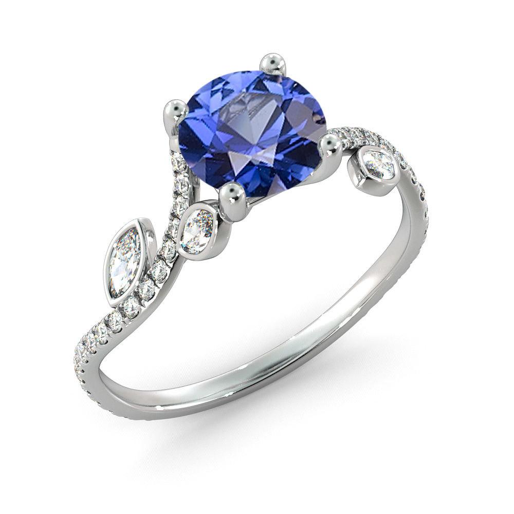 A beautiful handmade engagement ring made of 14K White Gold set with a 7MM L Sapphire. This ring can be set with any stone you choose or in any carat weight. The emerald in this ring is lab created.
 
 Sapphire details:
 Main Stone: Sapphire 
