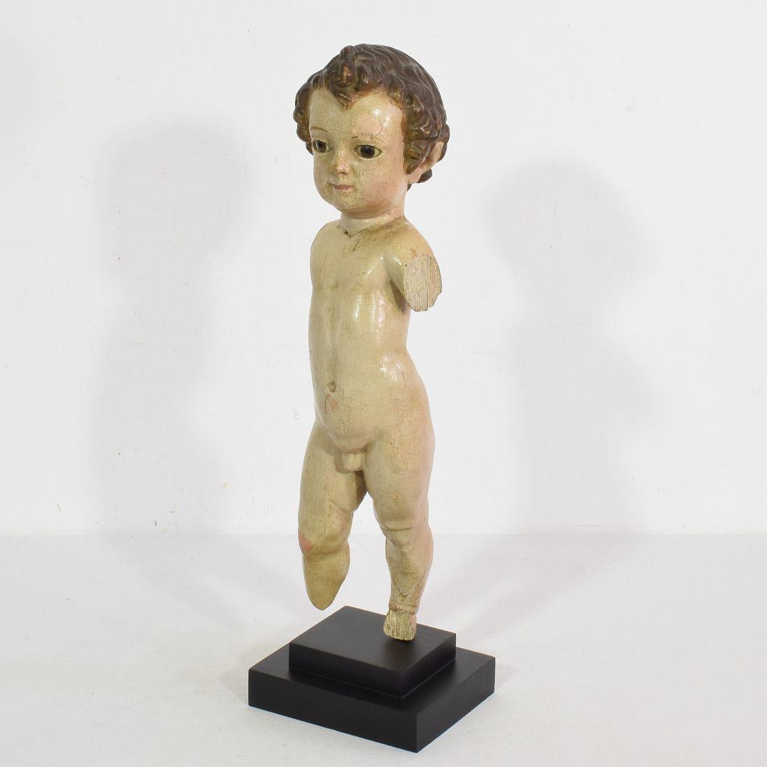 V ery beautiful baroque baby Jesus with glass eyes, Spain, circa 1650-1750.
Weathered and losses.
Measurements include the wooden base.