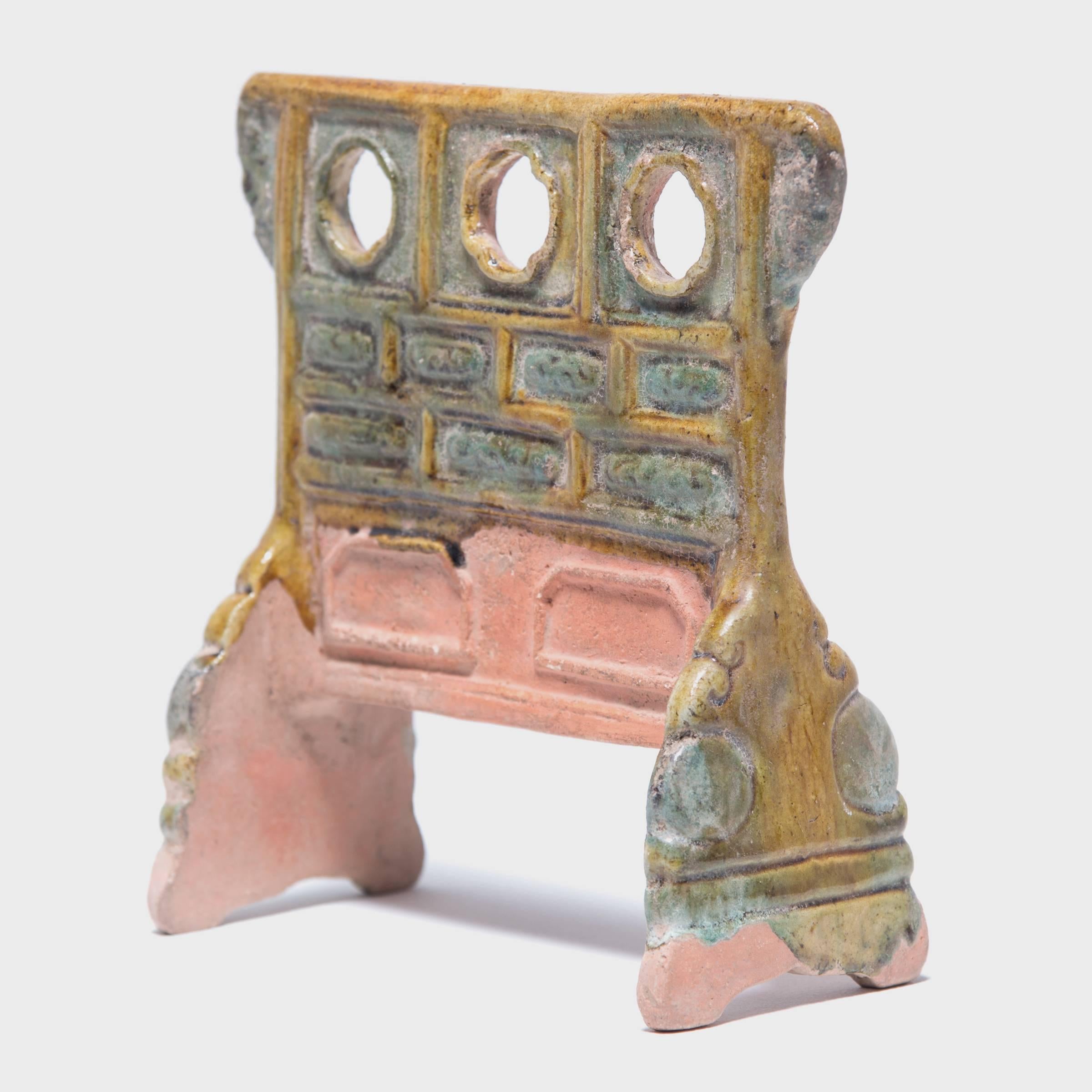 This miniature robe rack made out of glazed ceramic is called a mingqi or “spirit object.” Mingqi were buried in tombs and represented all of the things the deceased might need in their next life or in the transition to getting there: weapons,