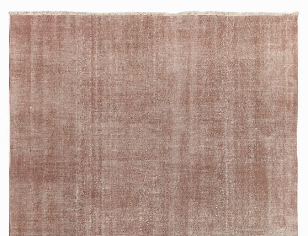 A vintage Turkish area rug re-dyed in soft pink, tan color for contemporary interiors.
Finely hand knotted, low wool pile on cotton foundation. Professionally washed.
Sturdy and can be used on a high traffic area, suitable for both residential and