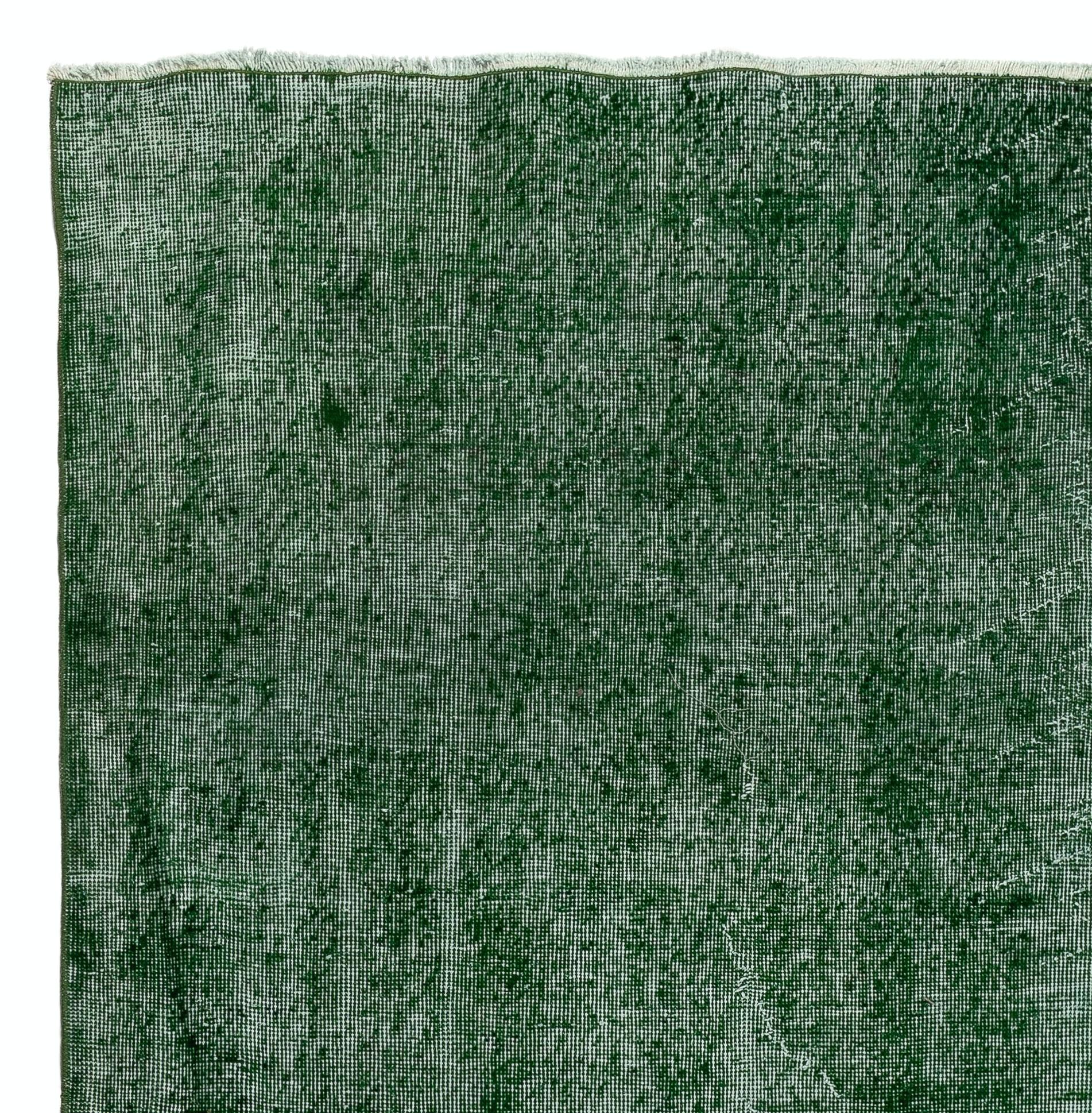 A vintage distressed Turkish area rug re-dyed in green color for contemporary interiors.
Finely hand knotted, low wool pile on cotton foundation. Professionally washed.
Sturdy and can be used on a high traffic area, suitable for both residential and