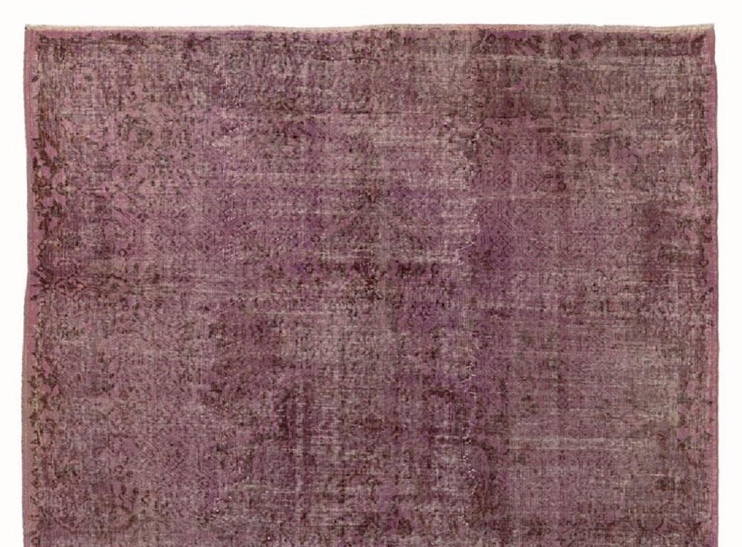 A vintage Turkish area rug re-dyed in purple color for contemporary interiors. Measures: 7 x 10 Ft.
Finely hand knotted, low wool pile on cotton foundation. Professionally washed.
Sturdy and can be used on a high traffic area, suitable for both