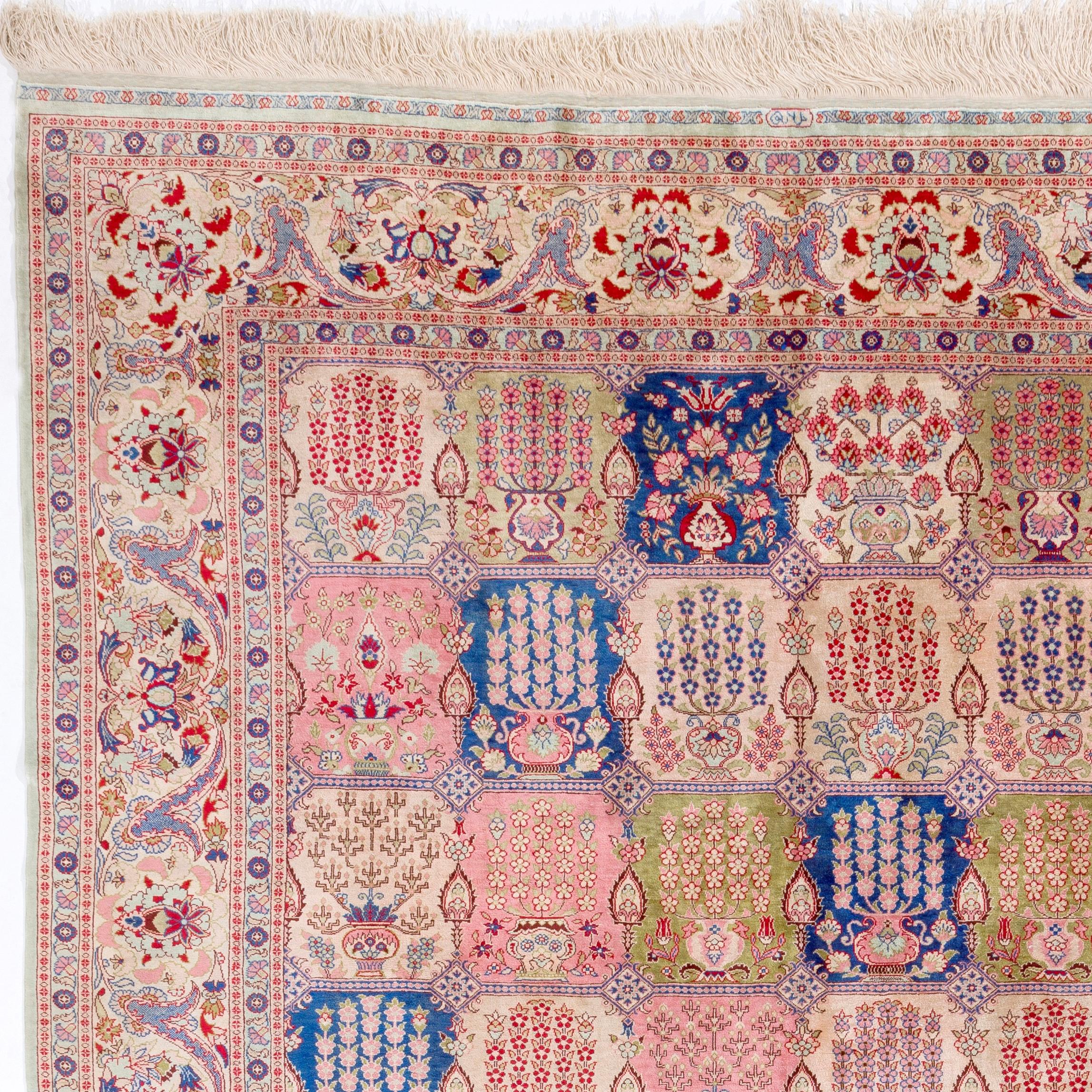 An exquisitely elegant silk Hereke rug with what is known as a ‘garden design’, featuring an overall vignette pattern. Each vignette depicts impeccably drawn delicate potted flowers in blossom such as roses, carnations and tulips. Impressive