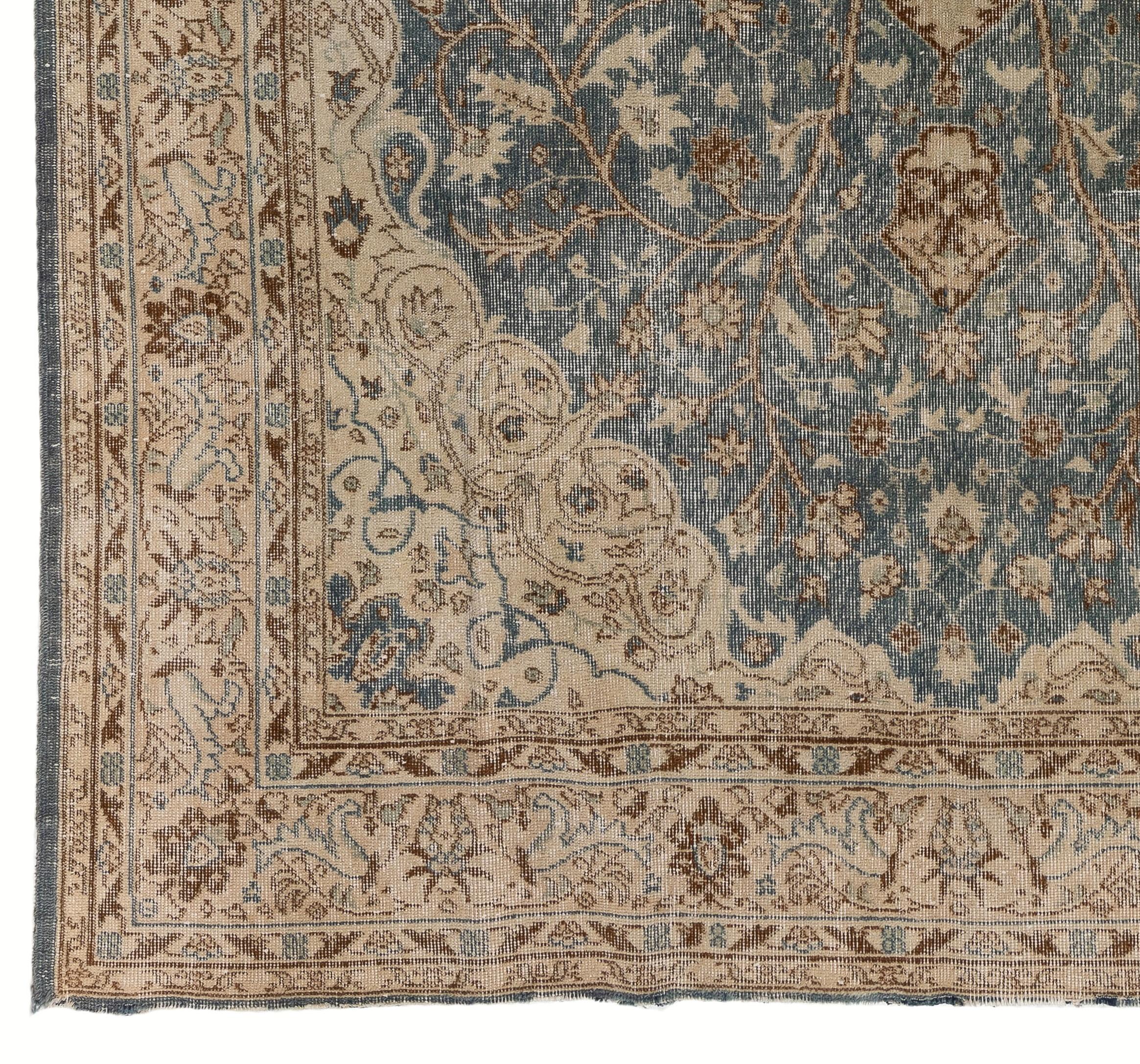 A finely hand knotted vintage rug from Turkey in a soft, faded color palette of navy blue, peach, beige, taupe, aqua and mint green. Measures: 7 x 10 Ft.
Low wool pile on cotton foundation featuring a medallion at the center surrounded by