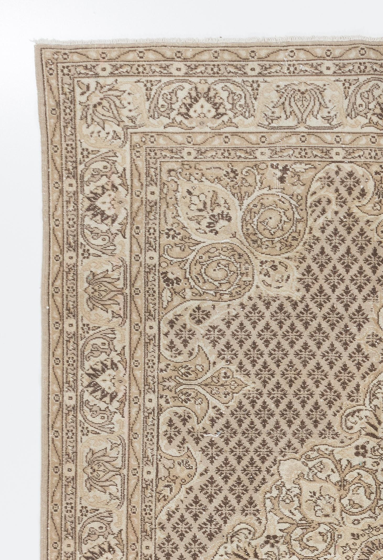 A finely hand-knotted vintage Turkish carpet from the 1960s featuring an elegant medallion design against a field filled with intricate quatrefoil motifs, elegant curvilinear corner pieces, individual tear-drop shaped motifs jutting out into the