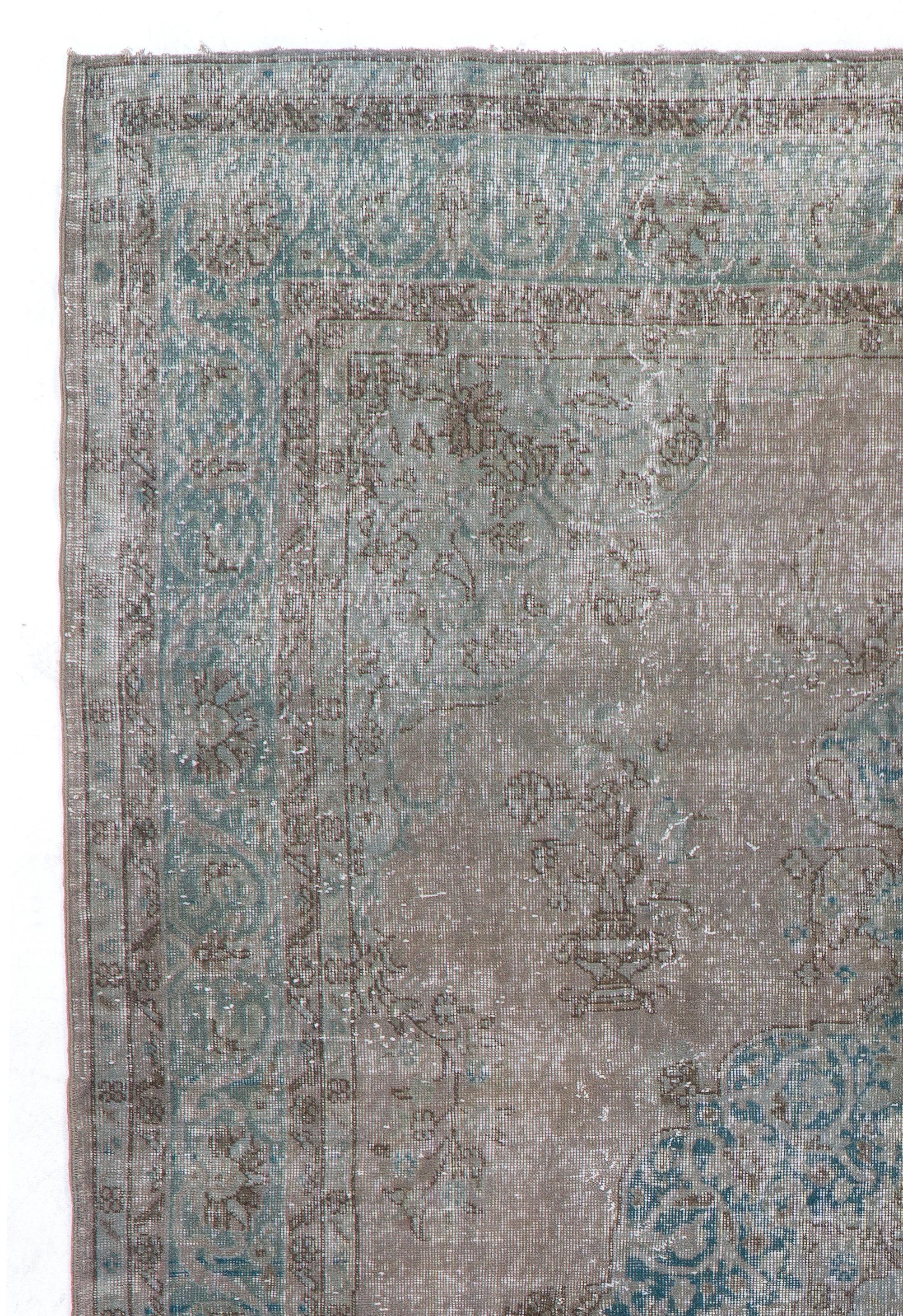 A vintage Turkish area with a lovely medallion design in light gray and light teal blue. It is finely hand knotted with low wool pile on cotton foundation. It is in very good condition with no issues, sturdy, professionally washed and suitable for