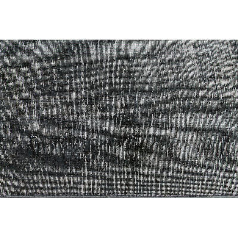 Distressed overdyed handwoven Persian style rug from Ren Collection rugs. This Persian style rug has been distressed and over-dyed to achieve a modern industrial design in a singular grey color. Created by the artisans of Pakistan. Measures: 7 x