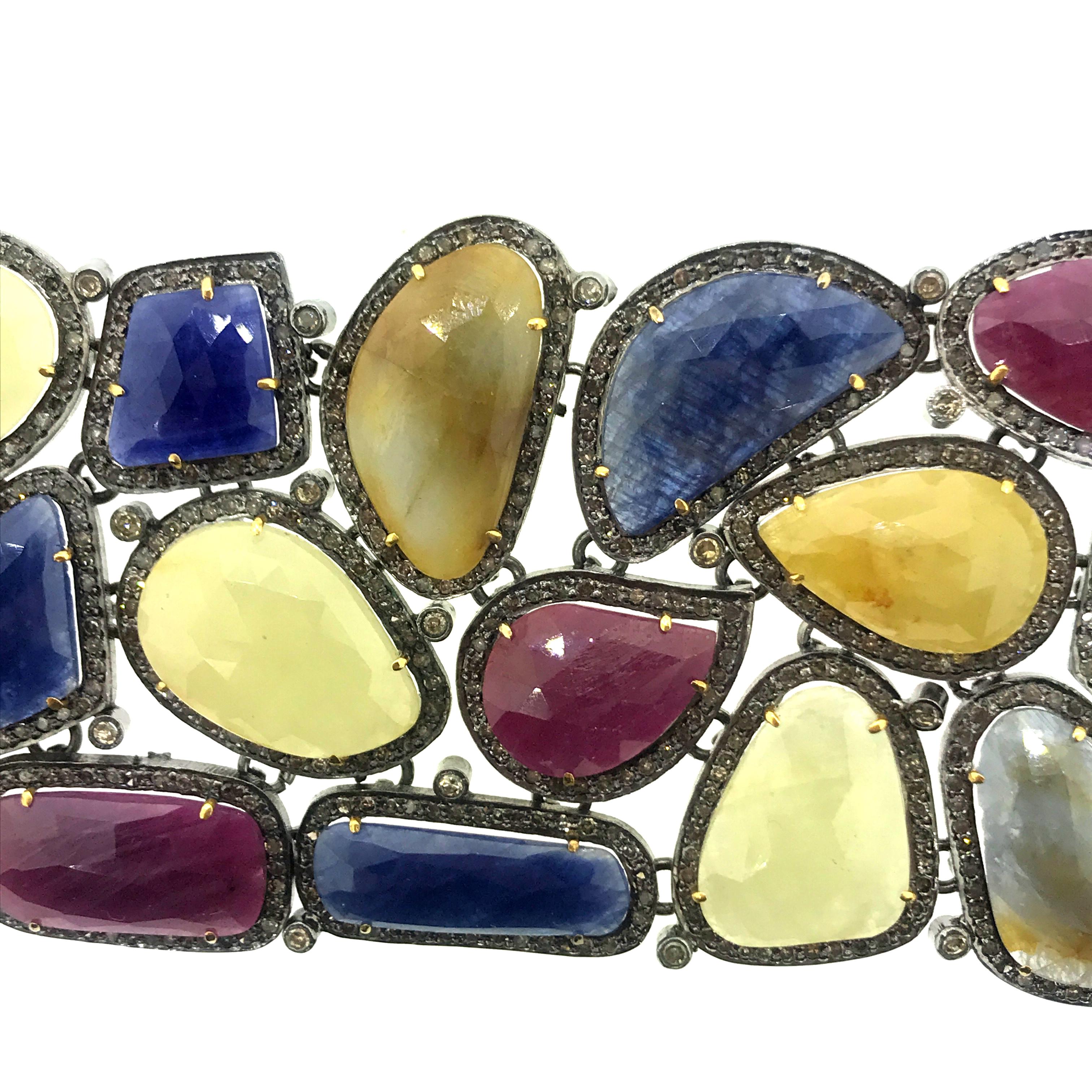 8 Inch Long 242.40 ct Multi Sliced Sapphire and 11.30 ct Champagne Diamond Bracelet set in Oxidized Sterling Silver with 14K Gold safety. It is one of  a kind bracelet with perfectly matched colors of sliced sapphires. Each stone is surrounded by a