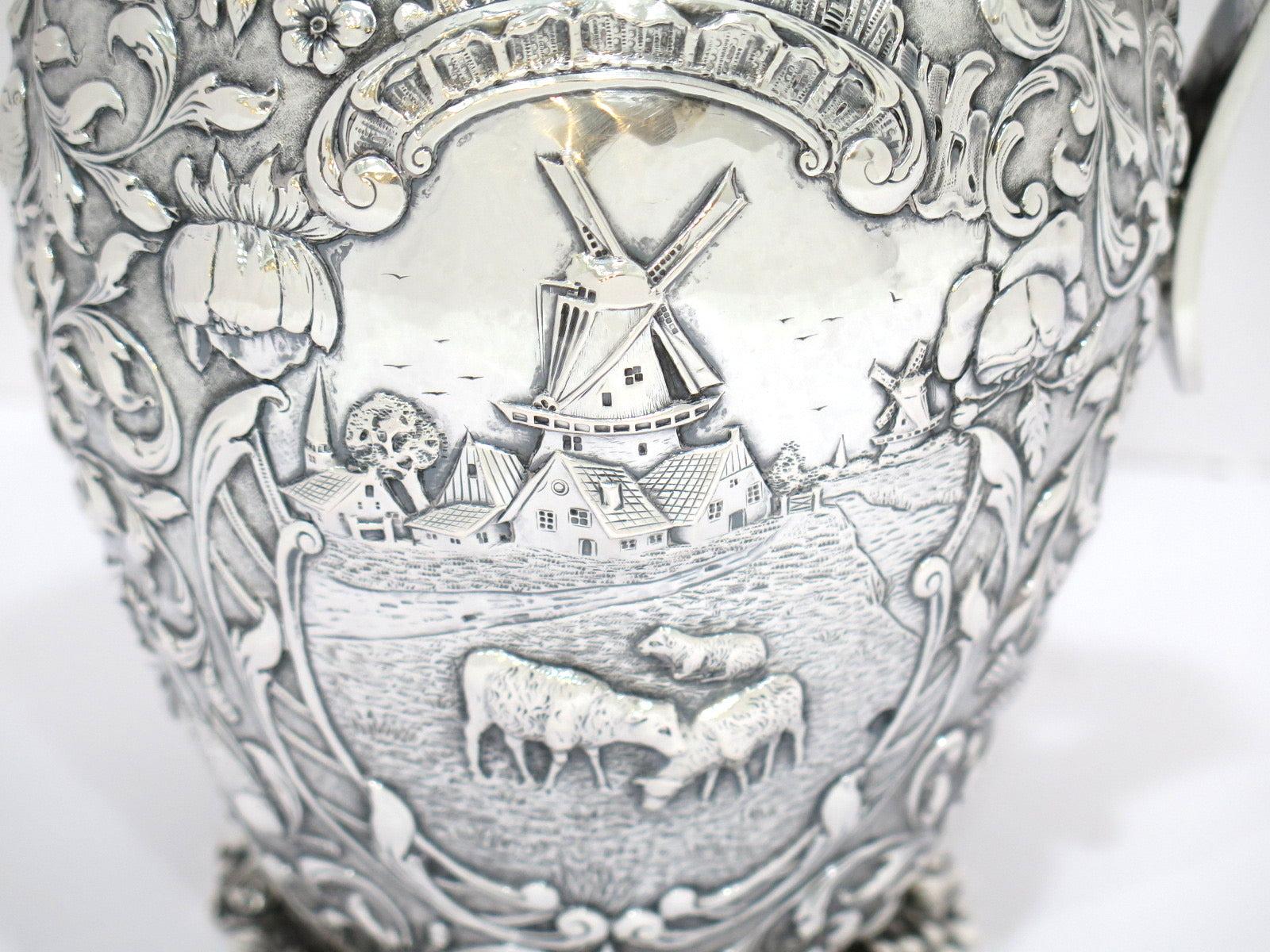 20th Century 8 7/8 in - European Silver Antique Dutch Scenery Flowers Birds Repousse Pitcher For Sale