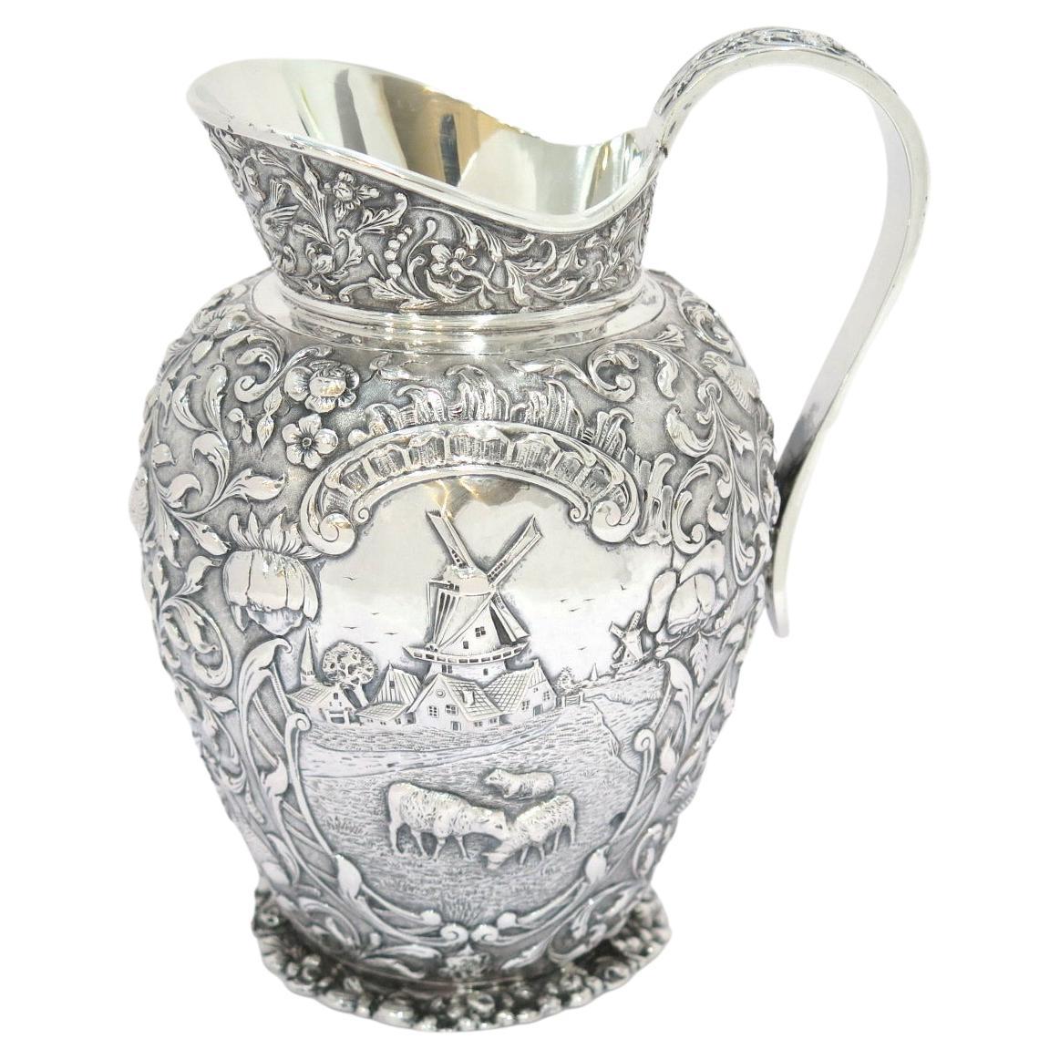 8 7/8 in - European Silver Antique Dutch Scenery Flowers Birds Repousse Pitcher For Sale