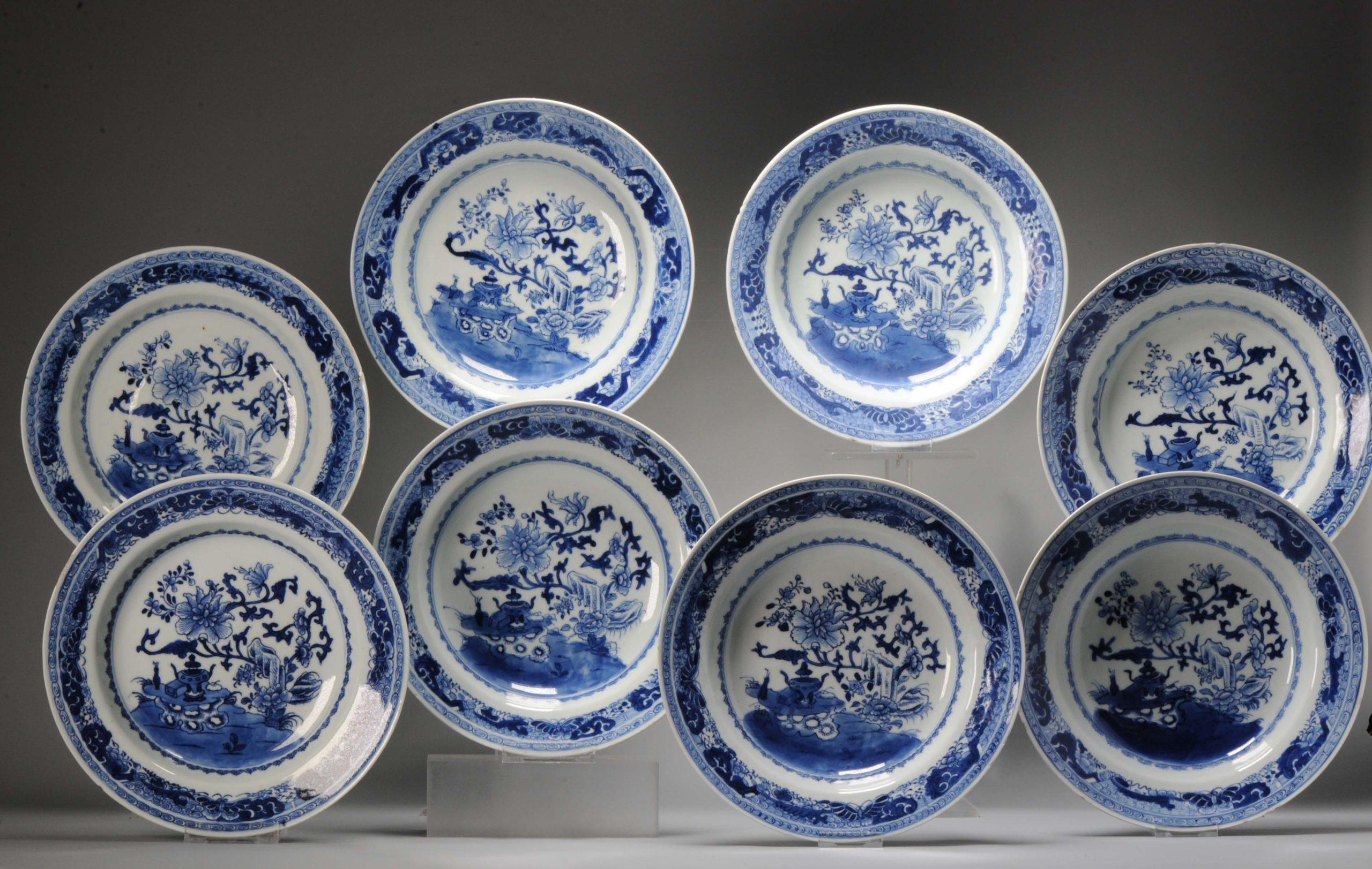A very nicely decorated SET of 8 deep dishes in Blue and white with a lovely and high quality garden scene with flowers, rocks and a table rock with an incense burner, books and a vase. The border with flowers, scrolls, geometric design and