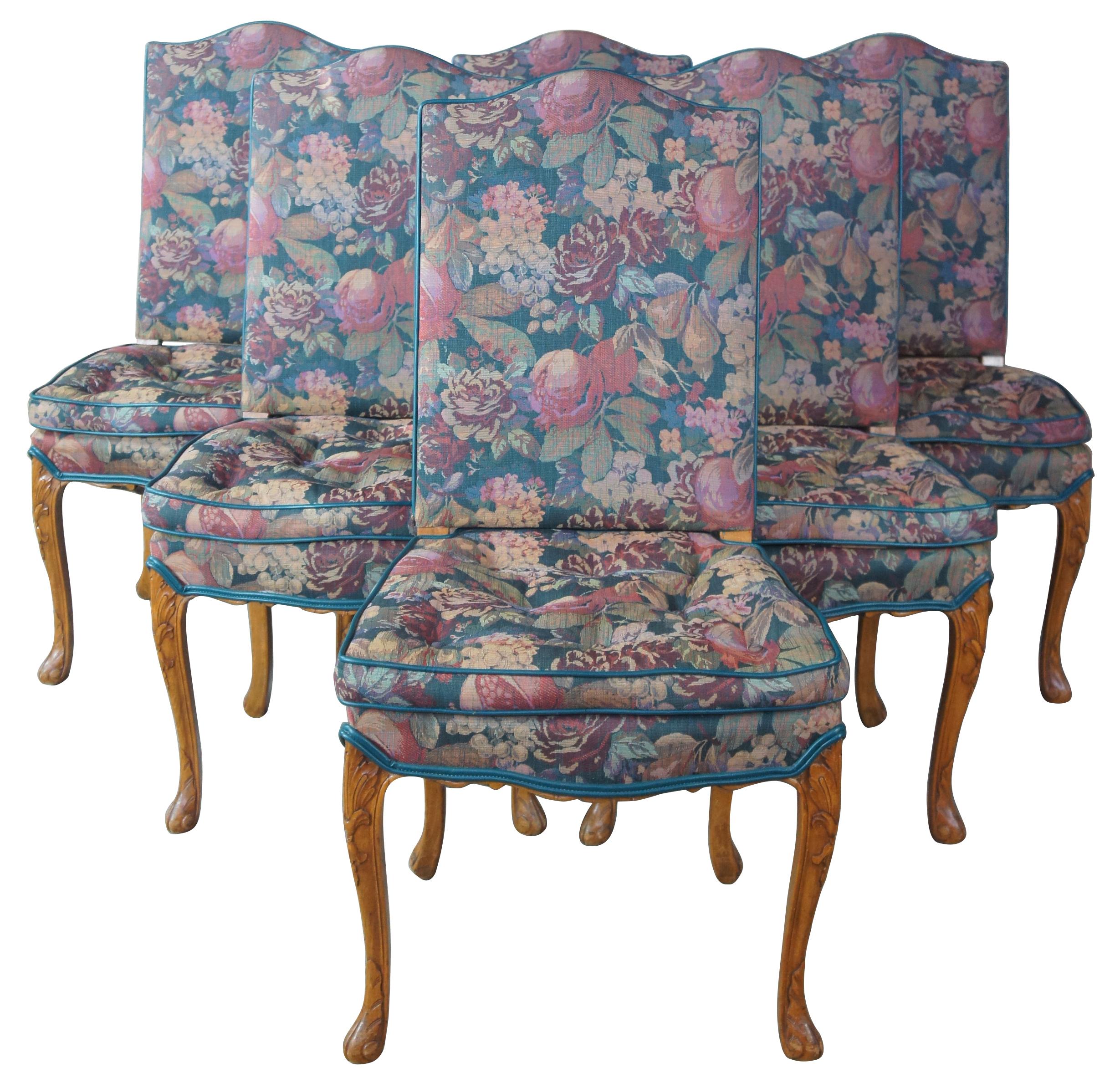 8 antique French Provincial carved walnut floral upholstered dining chairs

Early 20th century French dining chairs. Made from walnut with intricately carved acanthus and scalloped accents. Fully upholstered with a floral fabric and built in