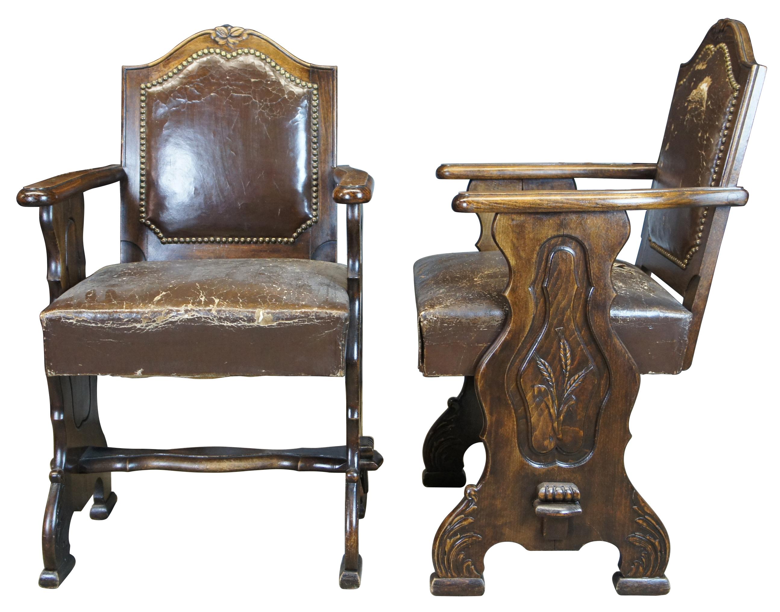 8 Antique French Country Old World oak dining chairs. An exquisite and unique form with molded side panels featuring wheat carvings and acanthus blocked feet. Upholstered in a brown leather with nailhead trim.