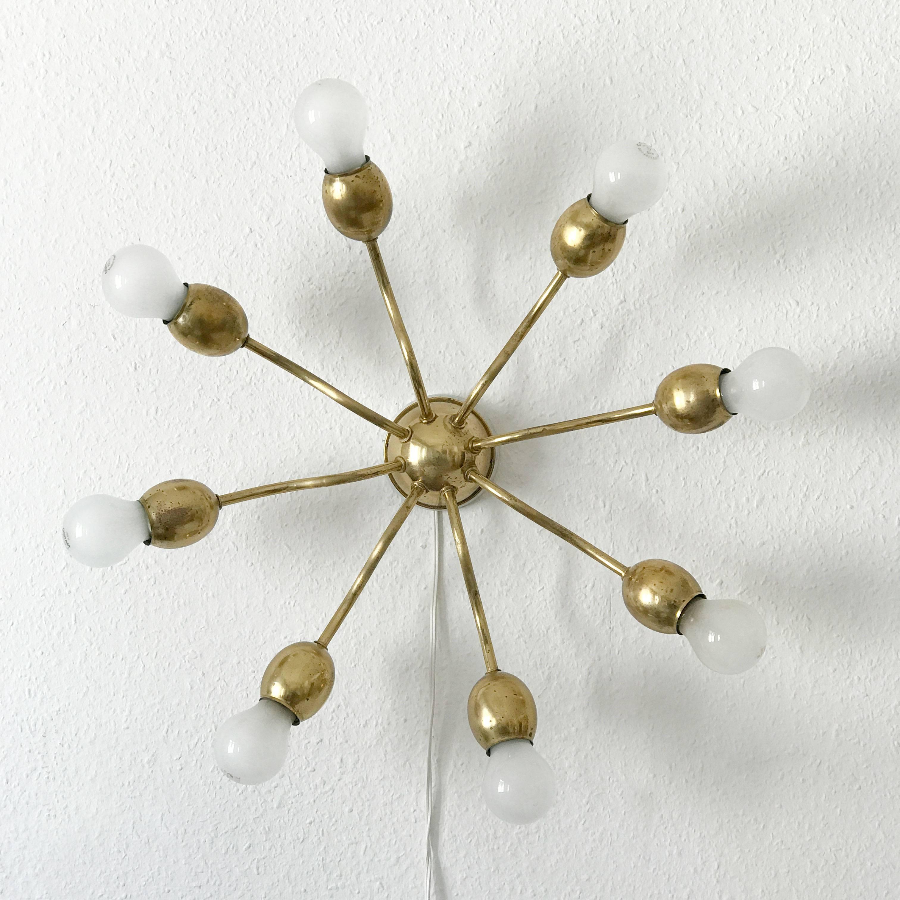 Elegant Mid-Century Modern Sputnik flush mount ceiling lamp wall light with eight arms. Designed and manufactured by J. & L. Lobmeyr, Vienna, Austria in 1950s. Bulb holders shaped like buds.
Executed completely in brass. The lamp needs eight E27