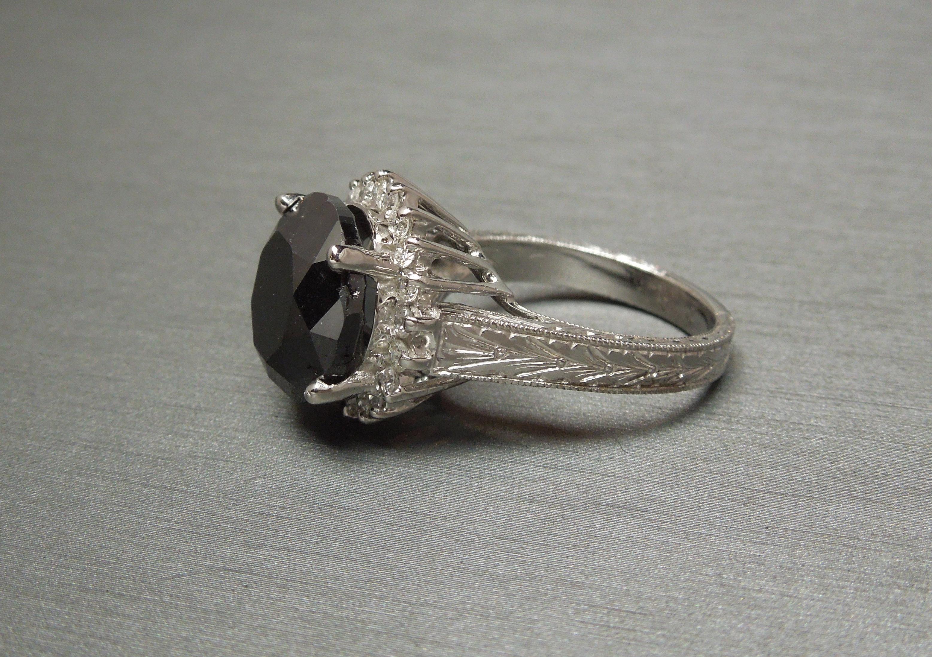 We are proud to offer this Black Diamond Crown Halo Solitaire Ring from our Beverly Hills Estate Collection. Constructed completely of 14 Karat White Gold, in an Art Deco inspired construction, accented with expertly hand-tooled Engraving