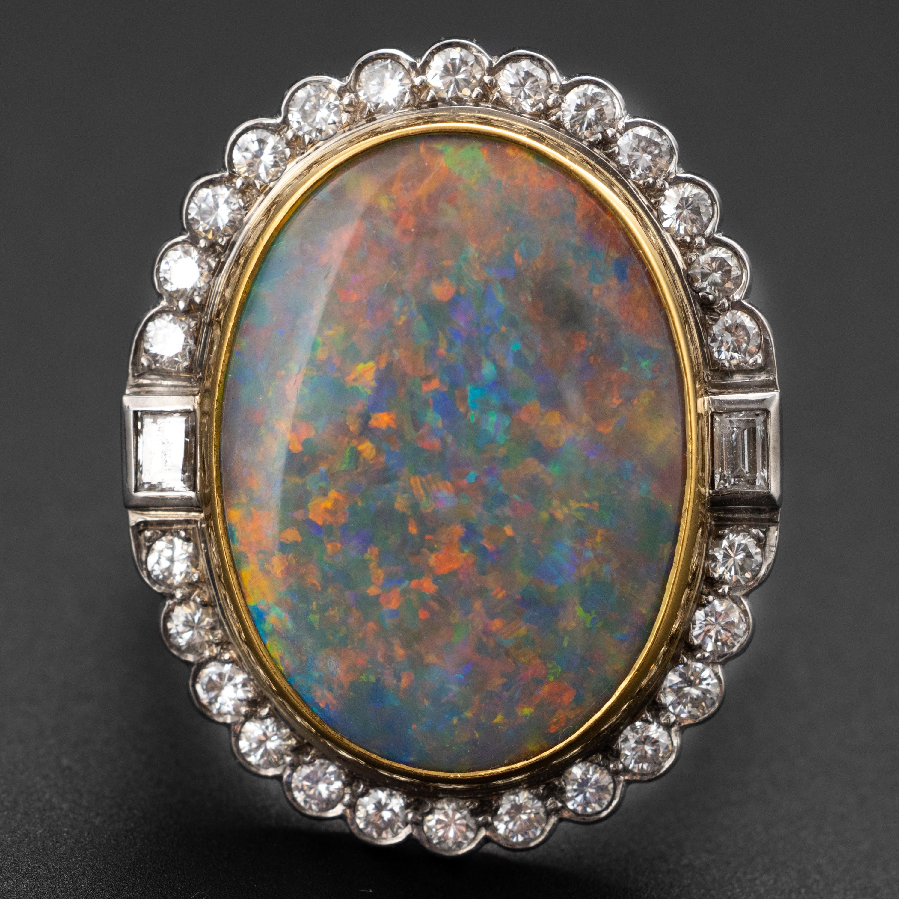 This haltingly impressive certified natural Australian black opal ring was created in England in 1988 by G. Bros of London. The stupendous opal displays every color in the spectrum —a rare and enormously desirable quality in Australian black opal.