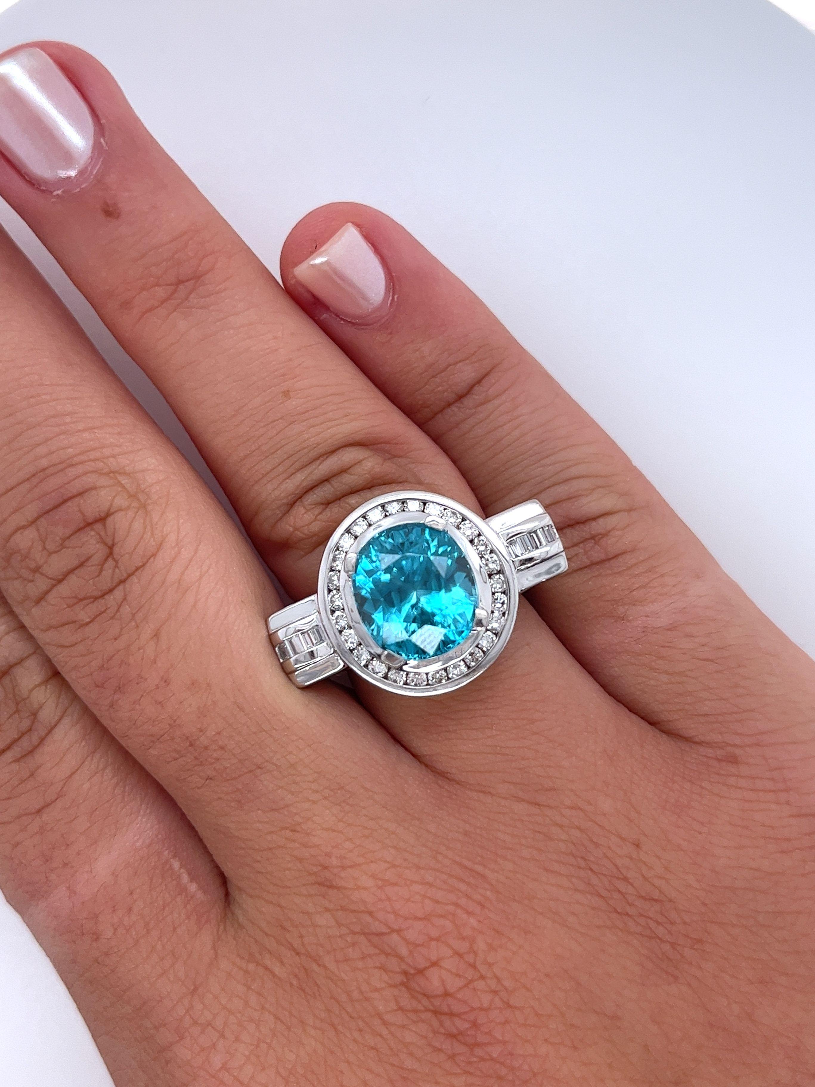 Vintage 8 carat oval cut Blue Zircon and Diamond ring. Featuring a platinum ring setting with an 18k gold floral filigree basket. The Blue Zircon center stone is exploding with brilliance, color, and luster. A remarkably clean gem.

The ring's