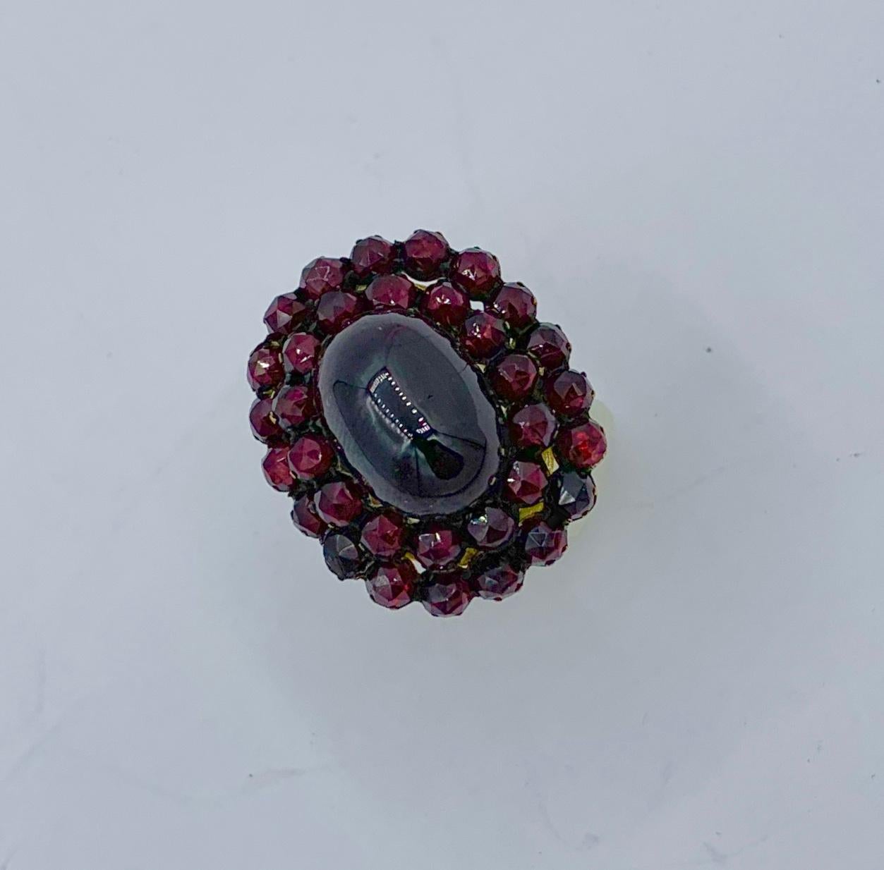 This is one of the finest Belle Epoque - Victorian Bohemian Garnet Rings have seen.  The fabulous ring is adorned with a magnificent Garnet Cabochon of approximately 8 Carats.  The tall Garnet cabochon has exquisite blood red color, a sensual shape