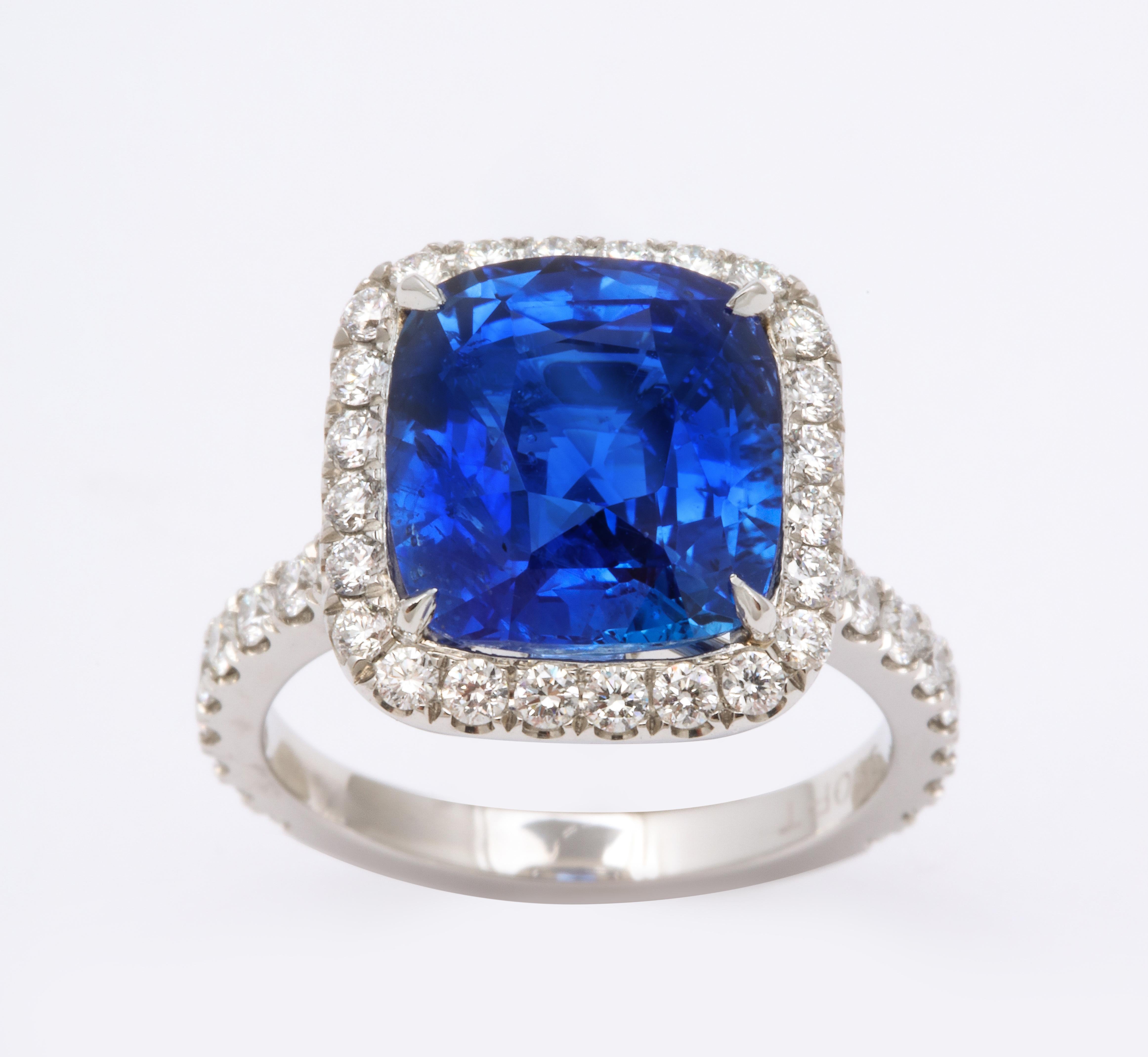 
A beautiful Certified Ceylon Blue Sapphire set in a custom diamond halo mounting. 

8.06 carat cushion cut blue sapphire 

1.02 carats of white round brilliant cut diamonds, set in platinum. 

This ring was designed to showcase the sapphire but