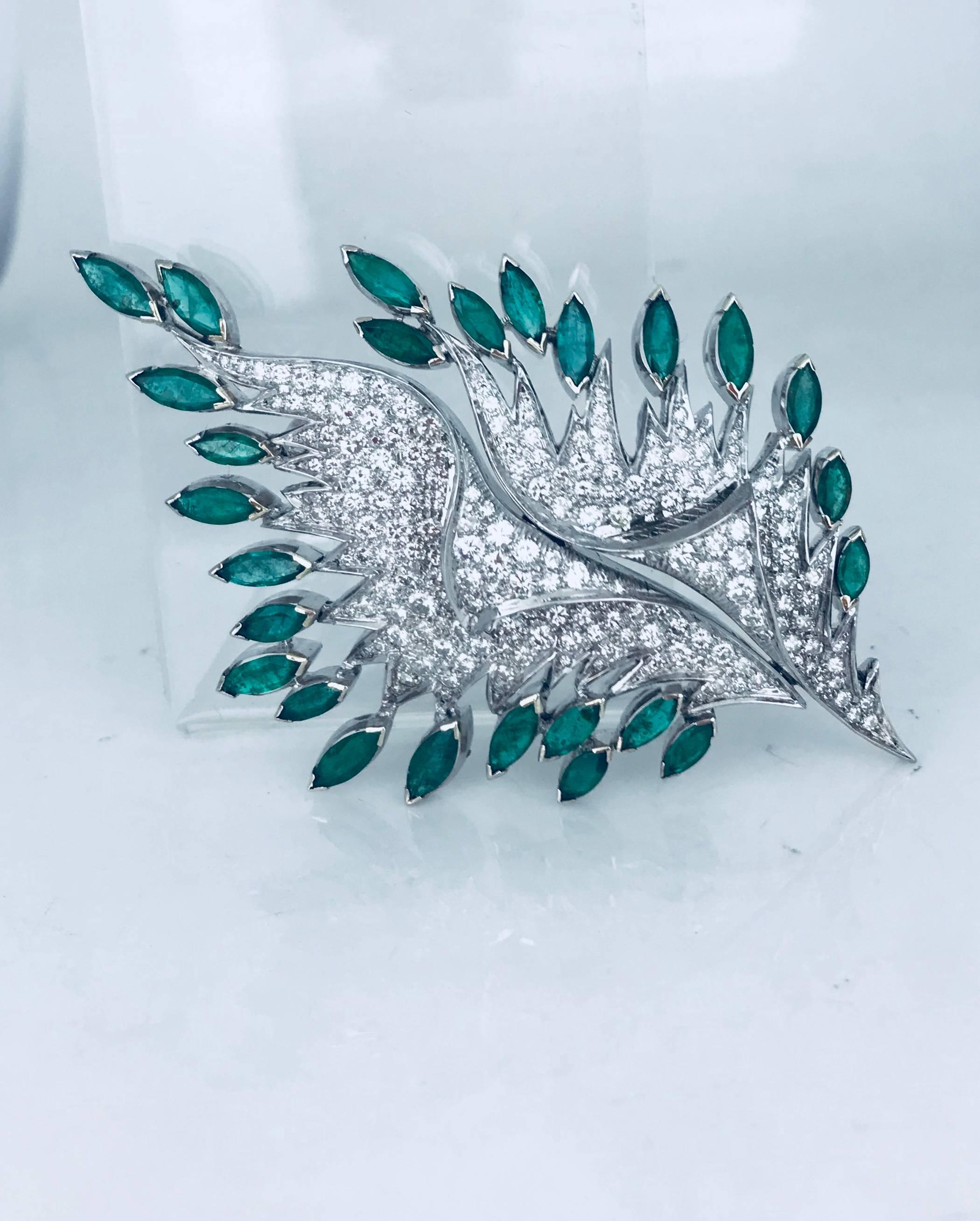 Platinum diamond and emerald retro-leaf, designed pin measuring 4 x 3 inches in diameter. The brooch consists of approximately 200 diamonds averaging .01-.10 points each (1.80-3.2 mm with an average of .05-.04 points each). The total diamond weight
