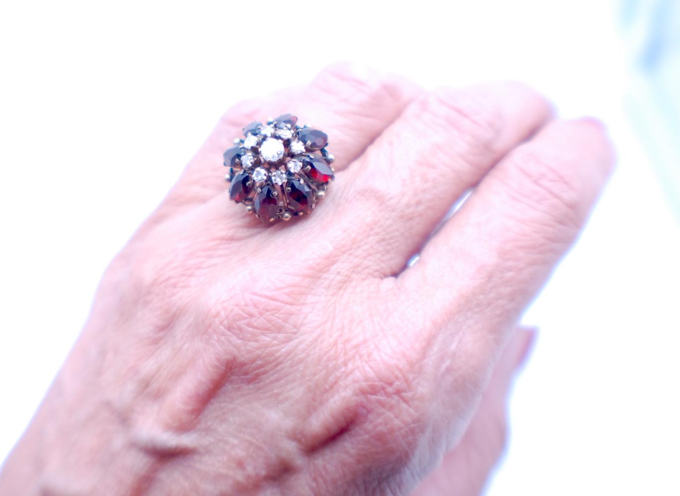Gorgeous retro-styled garnet and diamond Temple Ring. 
The ring measures tall 12.45 mm with a diamond centered and surrounded by more diamonds. (8) Marquise garnets move the eye upward to the Temple effect of this ring,
14 karat yellow gold 
Ring