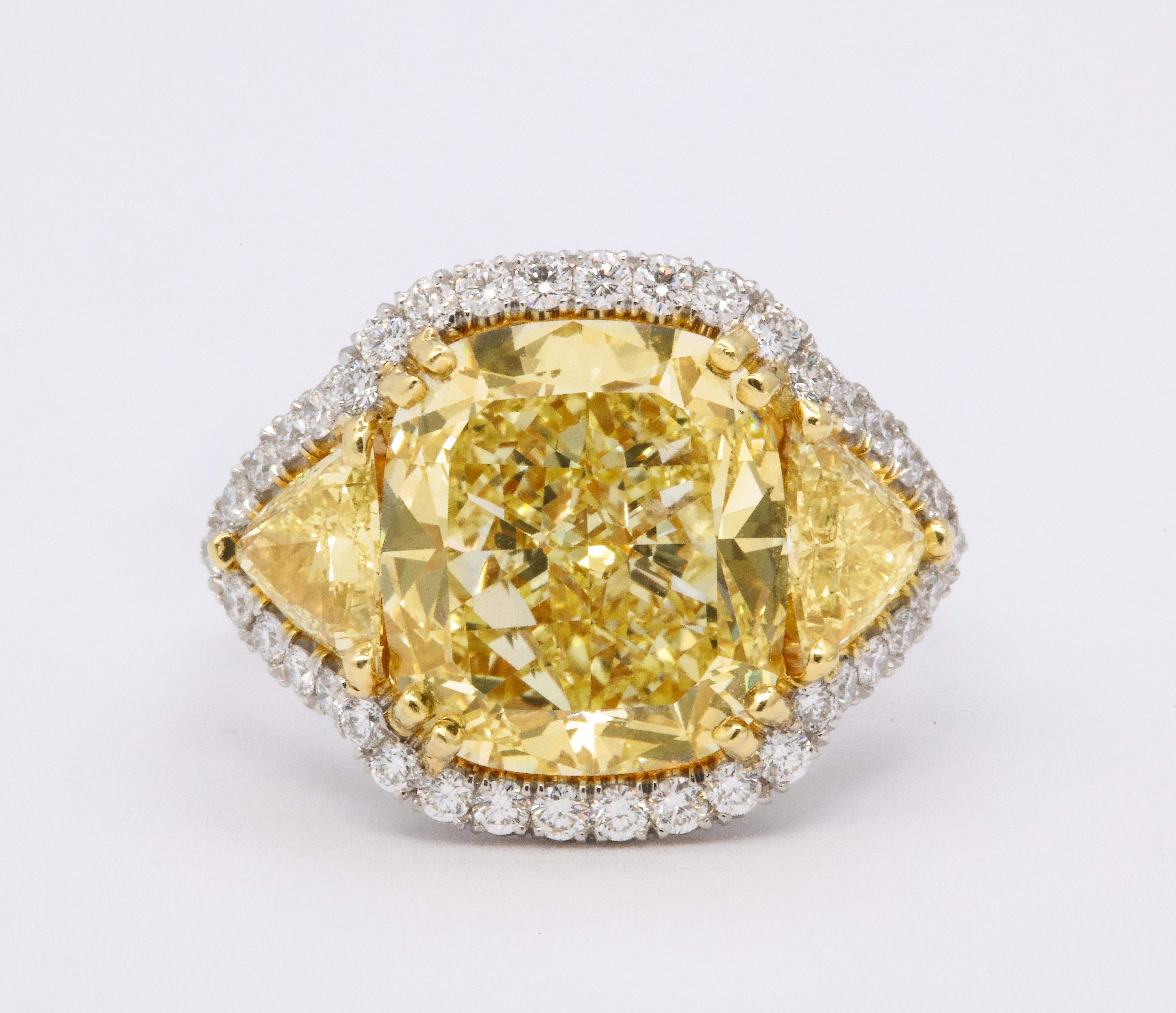 
An incredible yellow diamond set in a unique custom mounting. 

This diamond has a rich yellow color and is full of life.

GIA certified 8.33 carat Fancy Yellow VS1 cushion cut diamond. 

Approximately 1.50 carats in matching yellow diamond