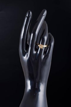 8-carat gold ring with white stone on floral shaped mounting. 1980s