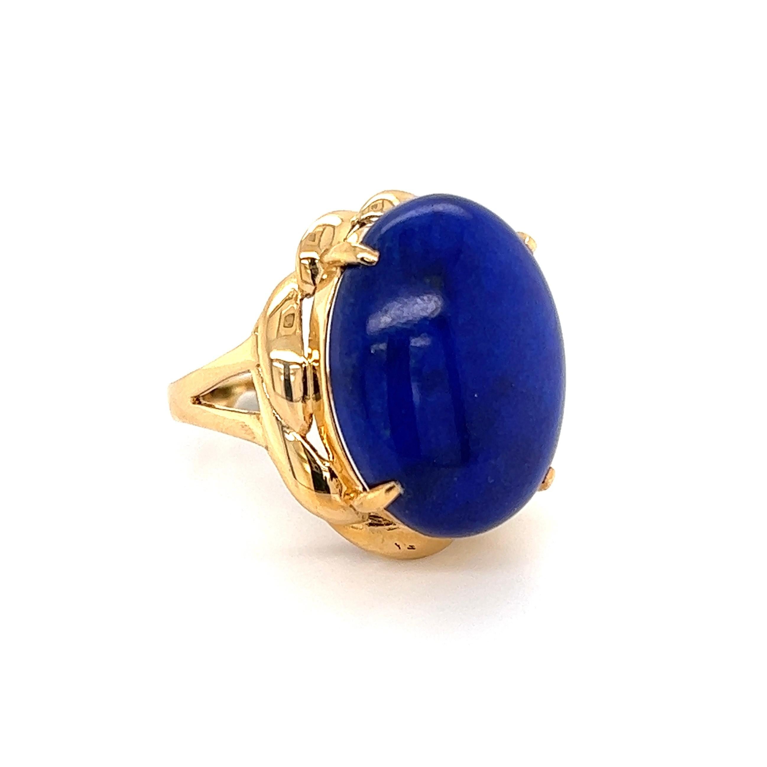 Awesome 8 Carat Lapis Lazuli Gold Cocktail Ring, centering a securely nestled 8 Carat Cabochon Lapis Lazuli. The ring is Hand crafted in 18K Yellow Gold. Measuring approx. 1.13” l x 0.80” w x 0.86” h. Ring Size 6.75, we offer ring re-sizing. Circa