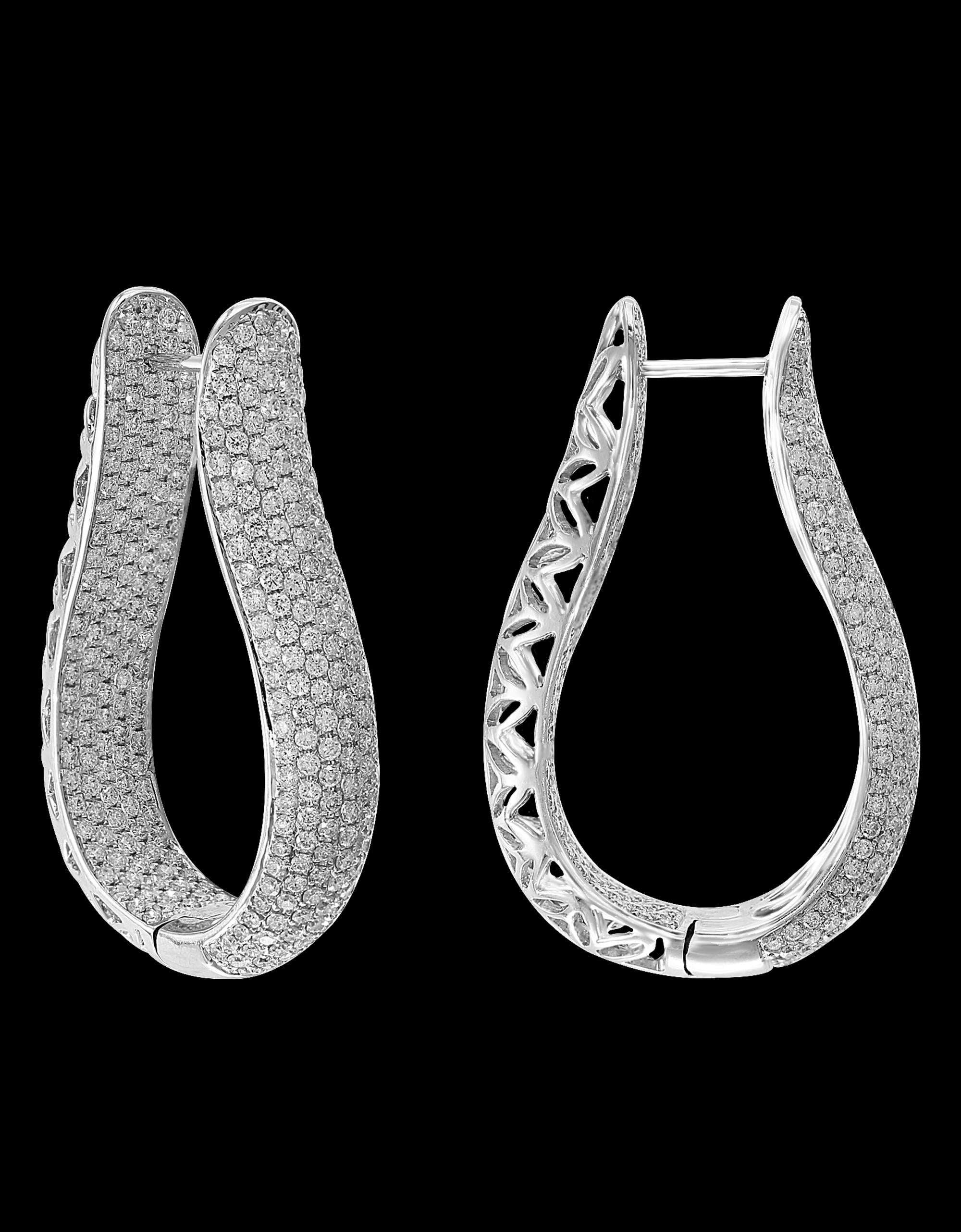 A fabulous pair of earrings with an enormous amount of look and sparkle!
These exquisite pair of earrings features round micropave  diamonds which are set without the prongs , weighing approximately 8 carat total set  in  18 karat white gold. These