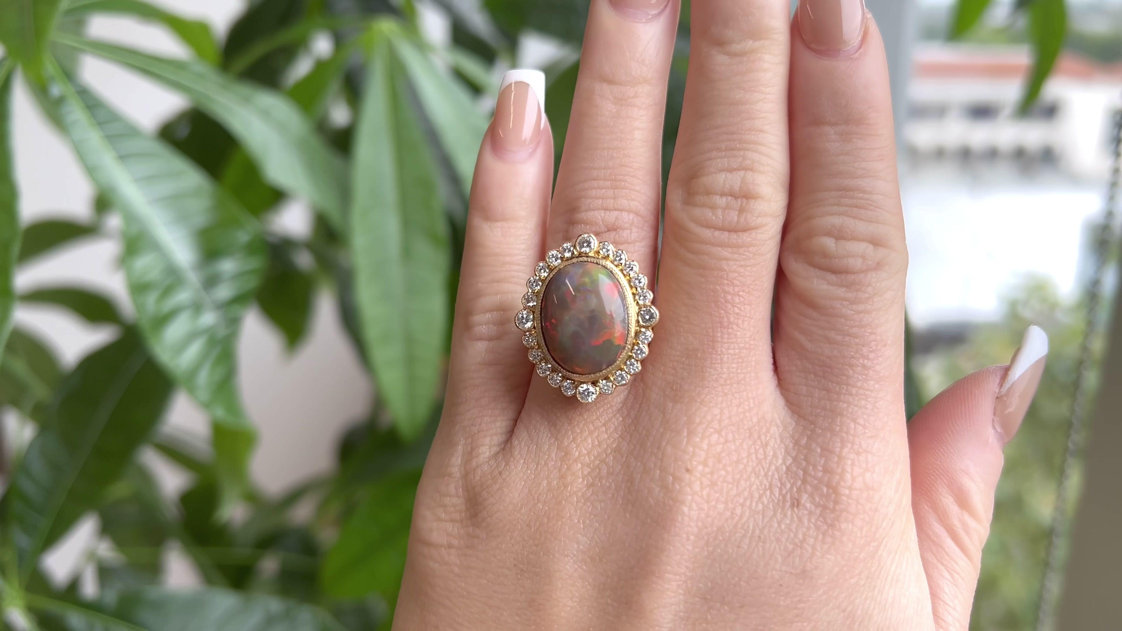 One Opal Diamond 18 Karat Gold Cocktail Ring. Featuring one oval opal of approximately 8.00 carats. Accented by 24 round brilliant cut diamonds with a total weight of approximately 1.00 carats, graded H color, SI clarity. Crafted in 18 karat yellow
