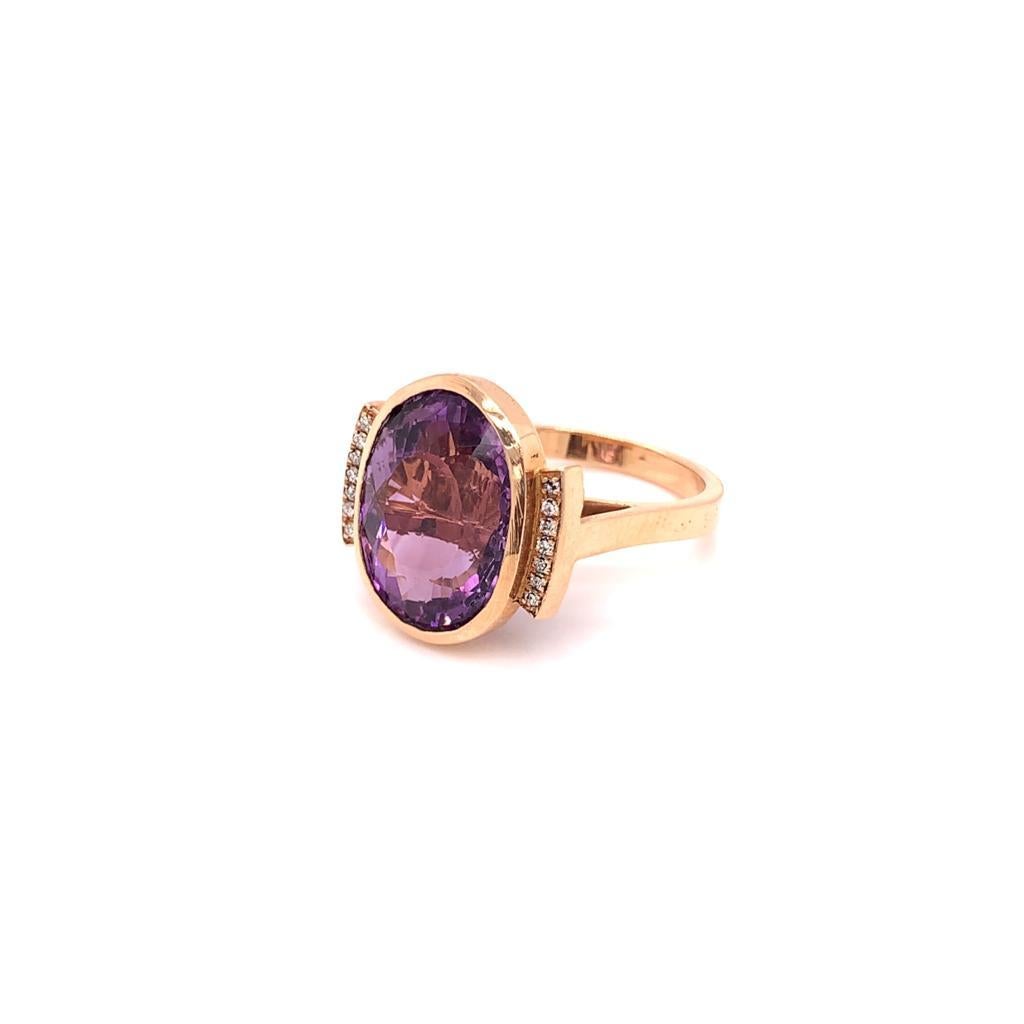 This 1930s style Cocktail Ring features a Natural Oval Brilliant Amethyst at its centre weighing approximately 8 Carats and mounted in 18K Rose Gold. Set with glittering Round Brilliant Diamonds weighing approximately 0.21 Carats, this Ring is an