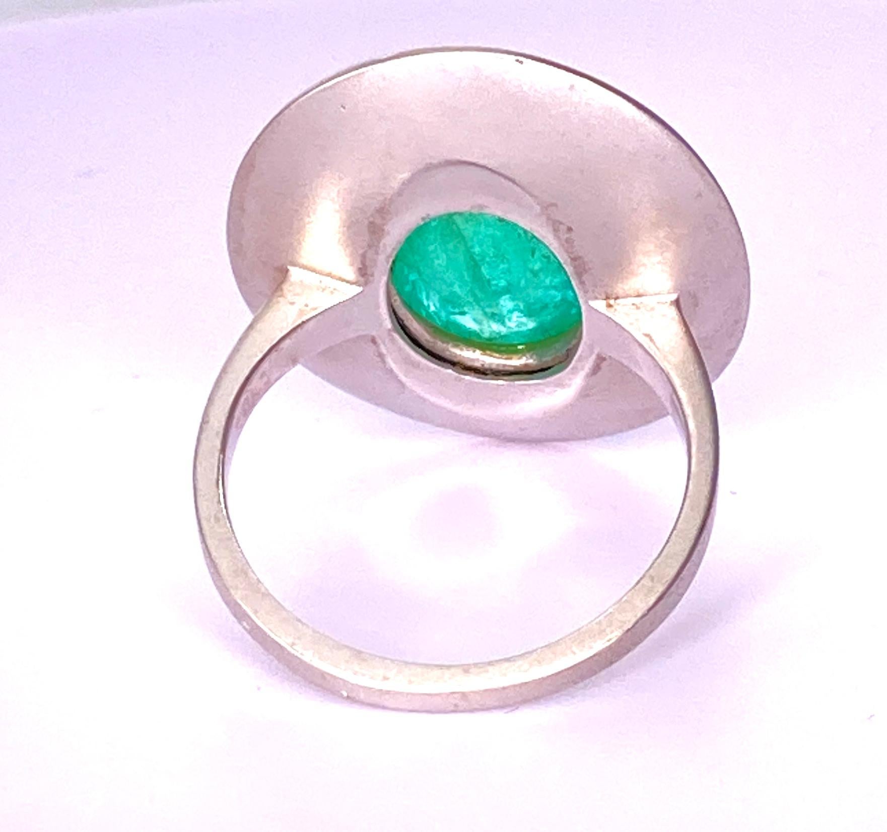 This 8 carat Paraiba Tourmaline Cabochon has both blue and green tones depending on the angle. Set in 18Kt White gold, Sand Blasted finish.