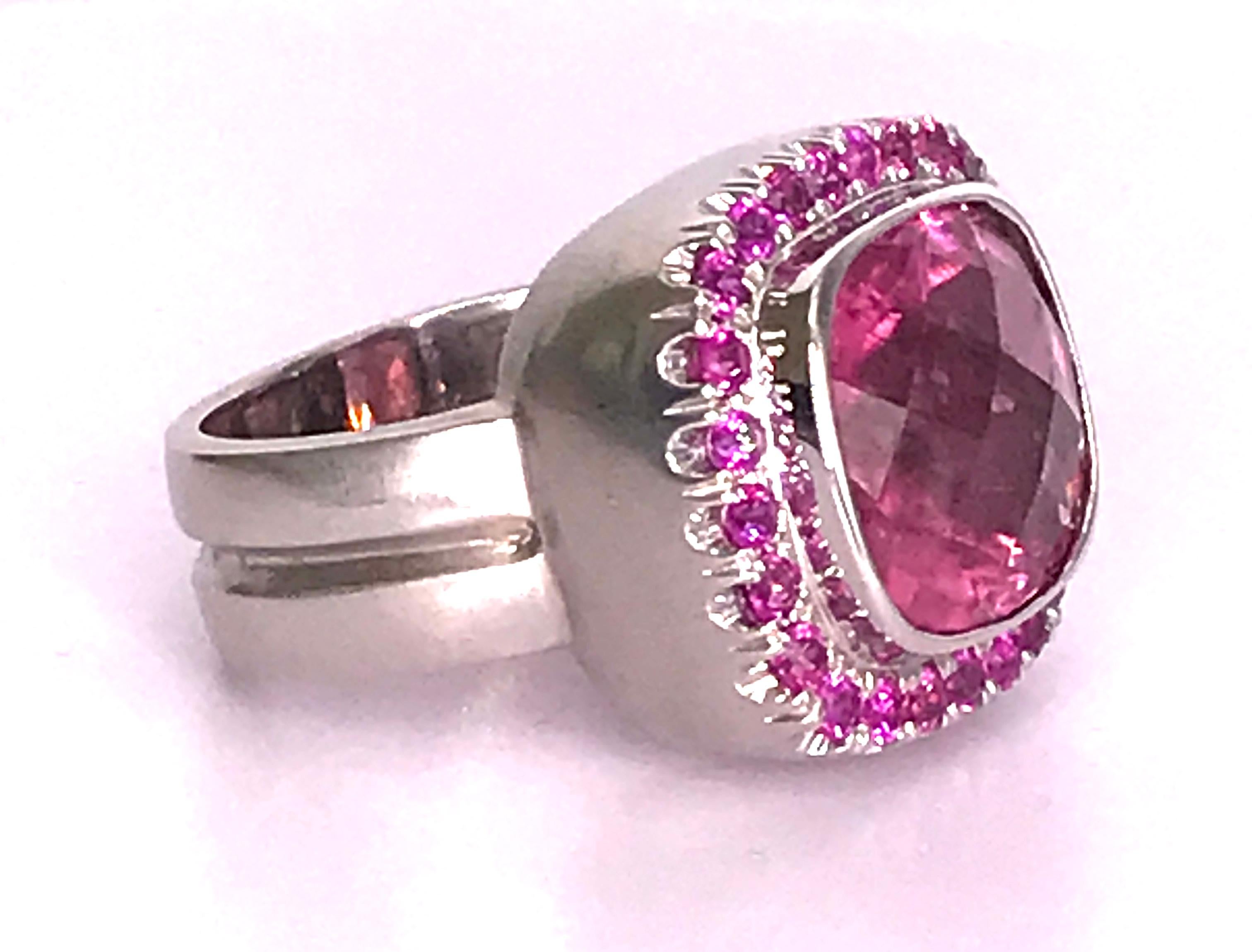 I fell in love with this very Pink 8 Carat Tourmaline enhanced by Pink Sapphires set in 18 Kt white Gold. Checkered board cut. The gold is sandblasted but can be polished.