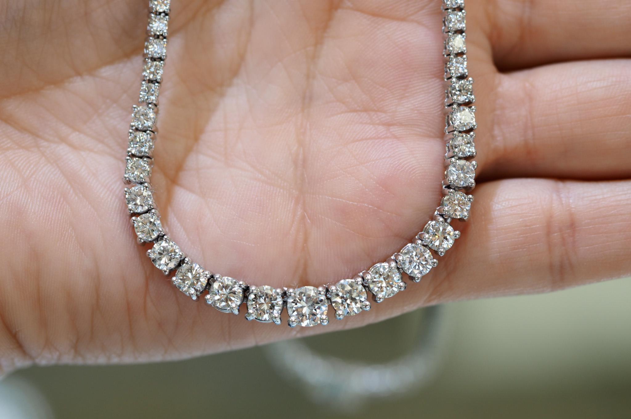 This stunning 14 Karat White Gold Round Brilliant Cut Diamond Tennis Necklace includes 143 individually 4 prong set diamonds. The total diamond weight is 8 carats. They taper in size from top to bottom from 1.75mm to a 5.10mm. The closure is a