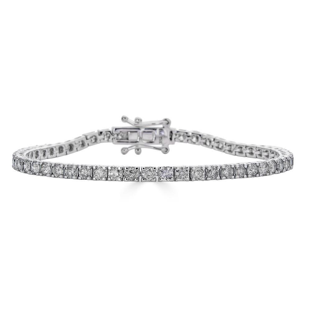This diamond bracelet is set in 14K white gold and features round diamonds with a total carat weight of 8.00 ct. The 4-prong setting ensures that each diamond is securely held, while still allowing light to pass through for maximum brilliance. The