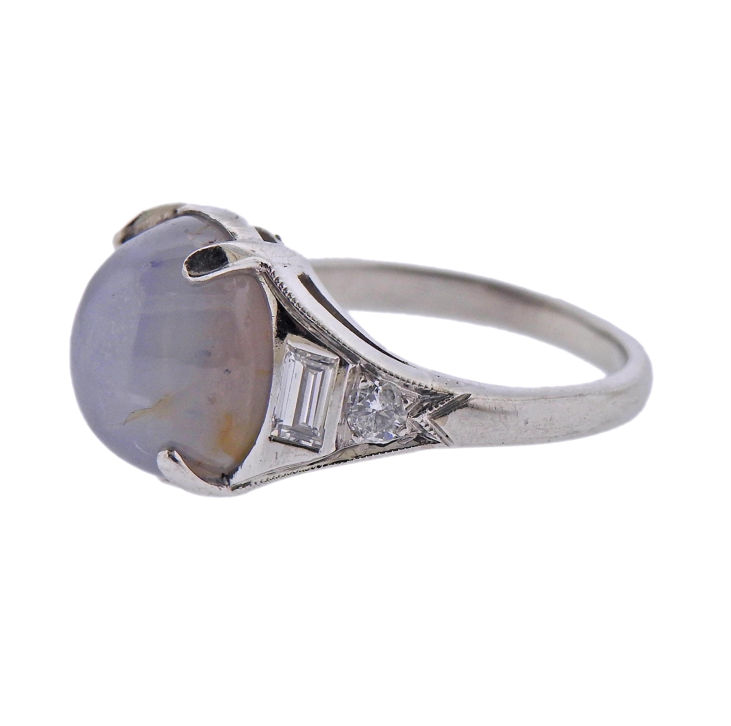 Platinum ring, with approx. 8 carat star sapphire cabochon, with  approx. 0.40ctw in side diamonds. Ring size - 4, ring top is 11mm wide. Marked with partially polished off platinum mark. Weight - 5.6 grams. 