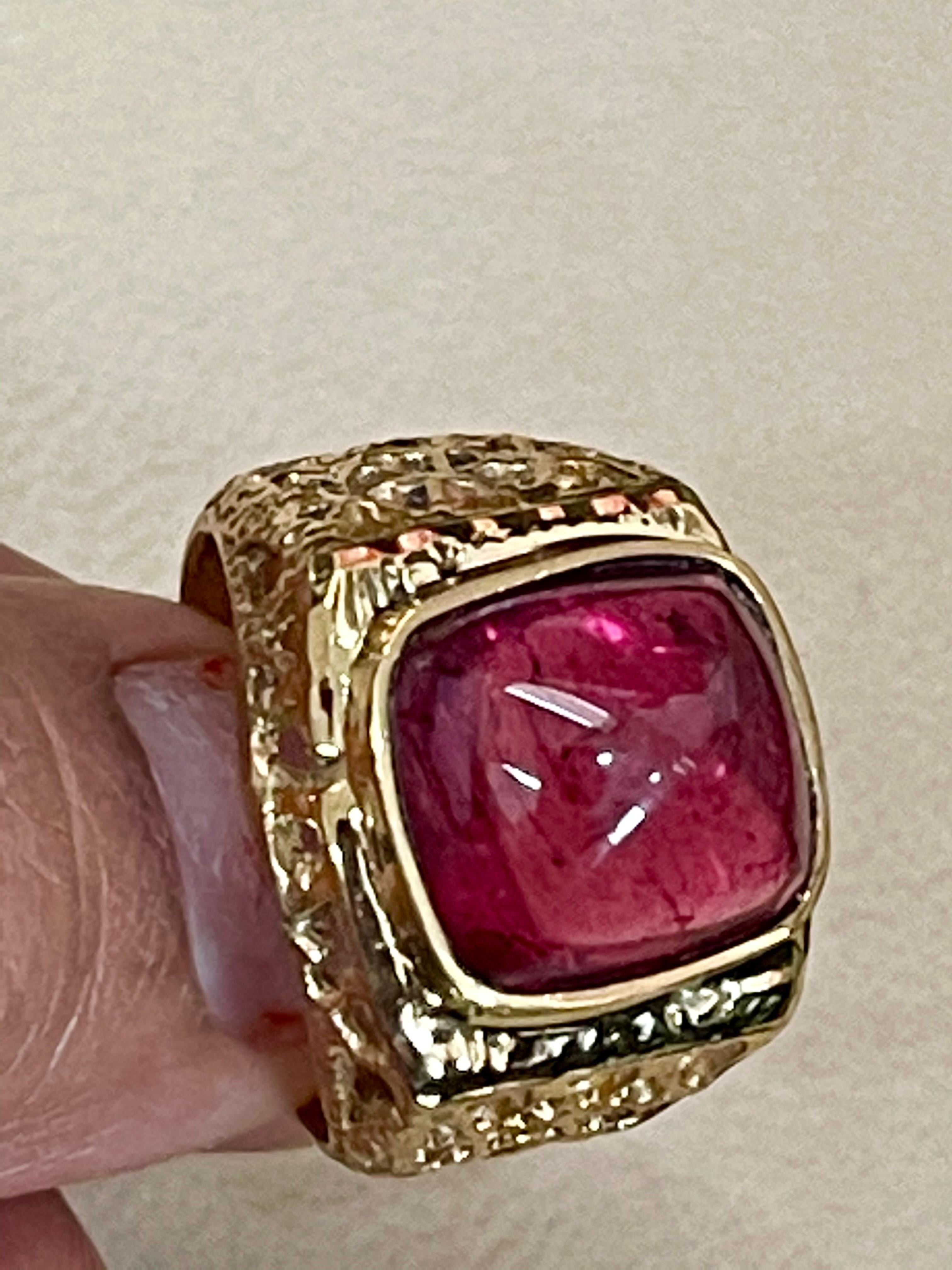 Approximately 8 Carat Oval Cut Sugar Loaf Cabochon Pink Tourmaline 14 Karat Yellow Gold Ring 
Men's Ring
8 Carat of Pink Tourmaline oval shape Sugar loaf cabochon surrounded by nice gold design.
Gold: 14 Karat Yellow  gold , Beautiful design
Weight: