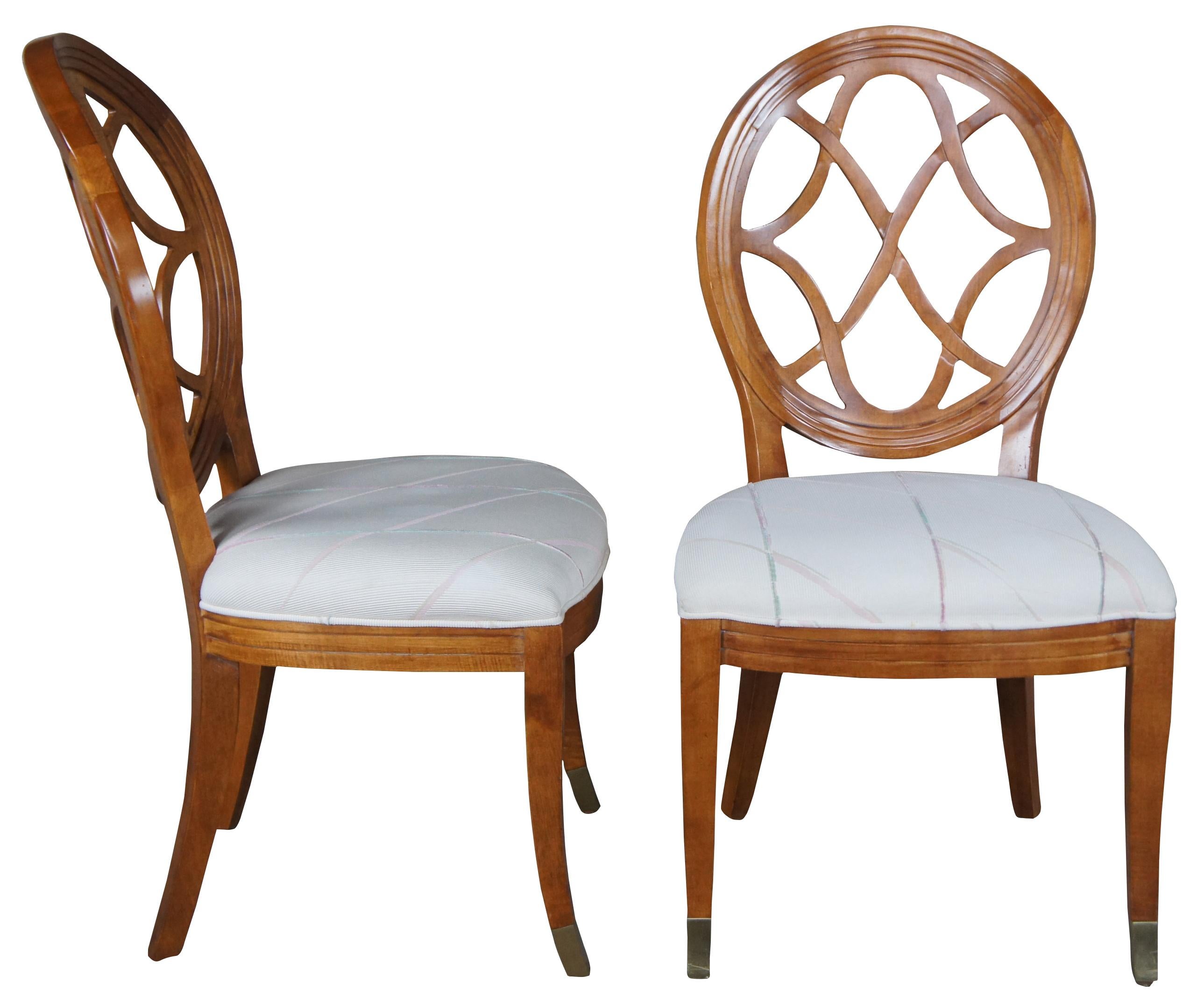 8 Vintage Century periced back side chairs 341-511, circa 1993. An oval or spoon shaped interlaced back, finished in their Maple Villadomain finish. The chairs are upholstered in a neutral fabric and supported by saber legs with brass caps.