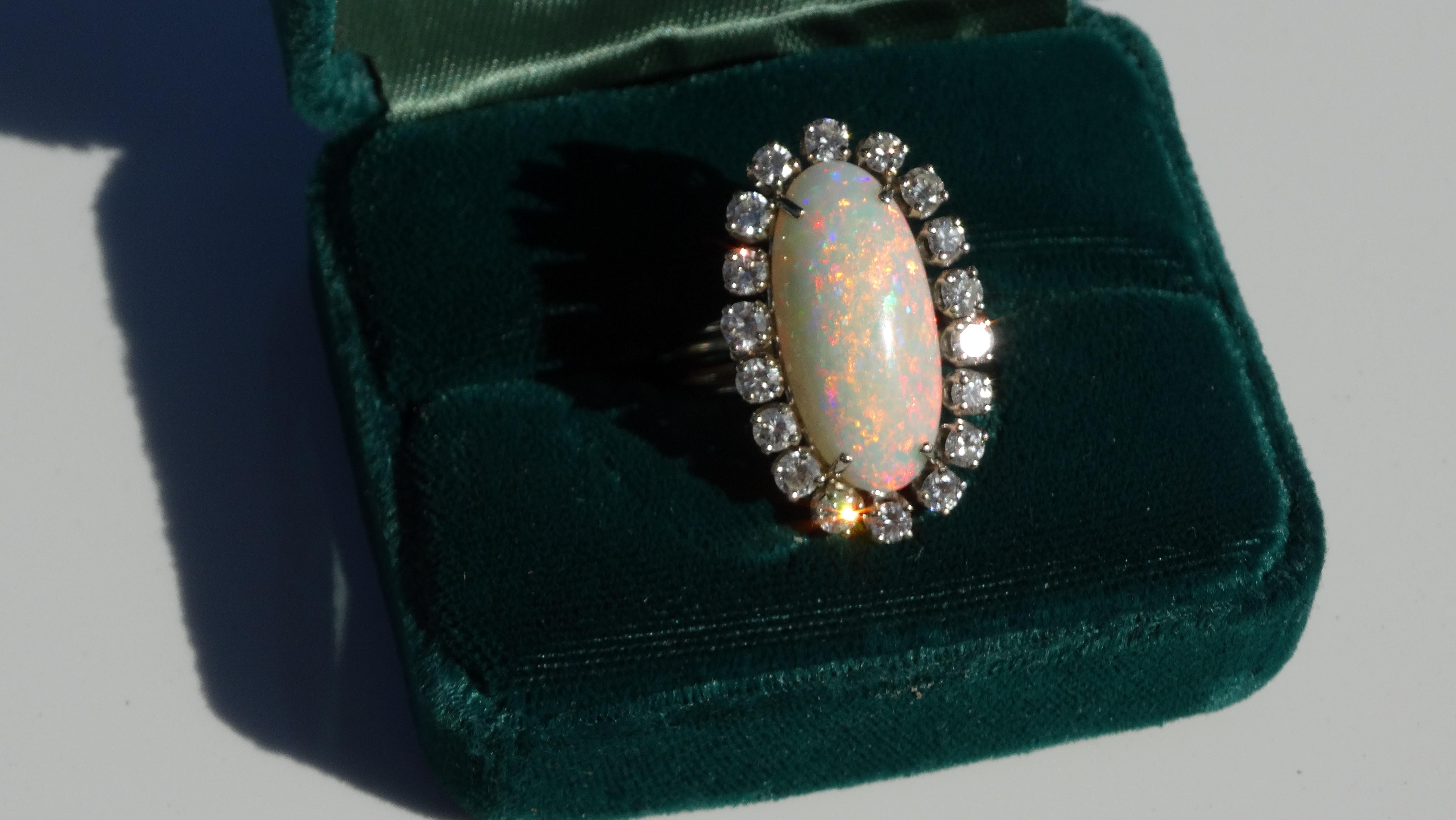 Gorgeous 14k white gold ring features an 8 ct Australian fire opal surrounded by twenty prong-set 1.4ct VS diamonds. This opal is has strong fiery colors. Sz 6.5 but of course it can easily resized. A beautiful statement cocktail ring to complete