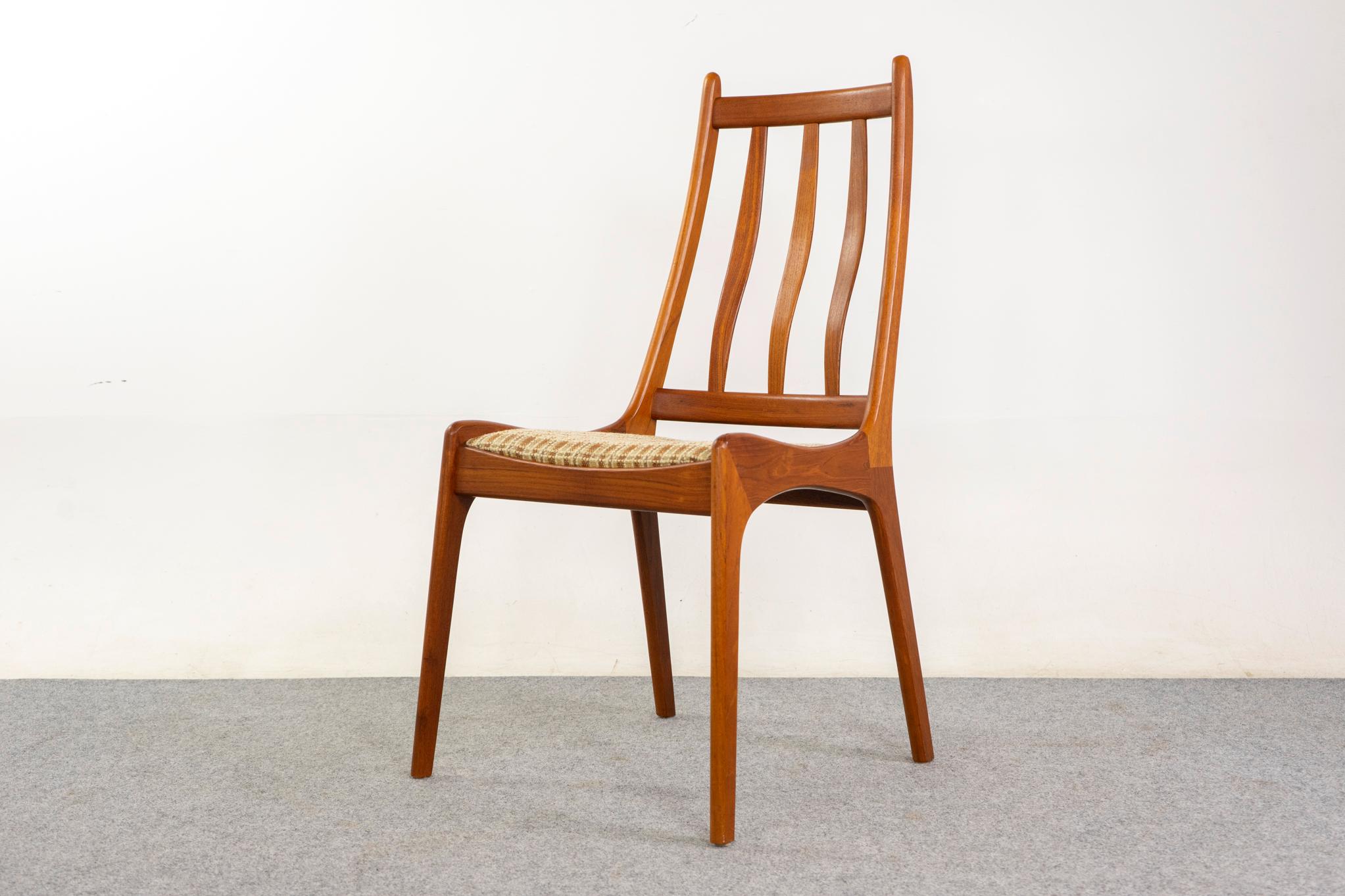 Teak Danish dining chairs, circa 1960s. Deep, rich-toned solid teak frames with beautifully curved slatted backrests and generous seats. Original tweed upholstery in nice condition.