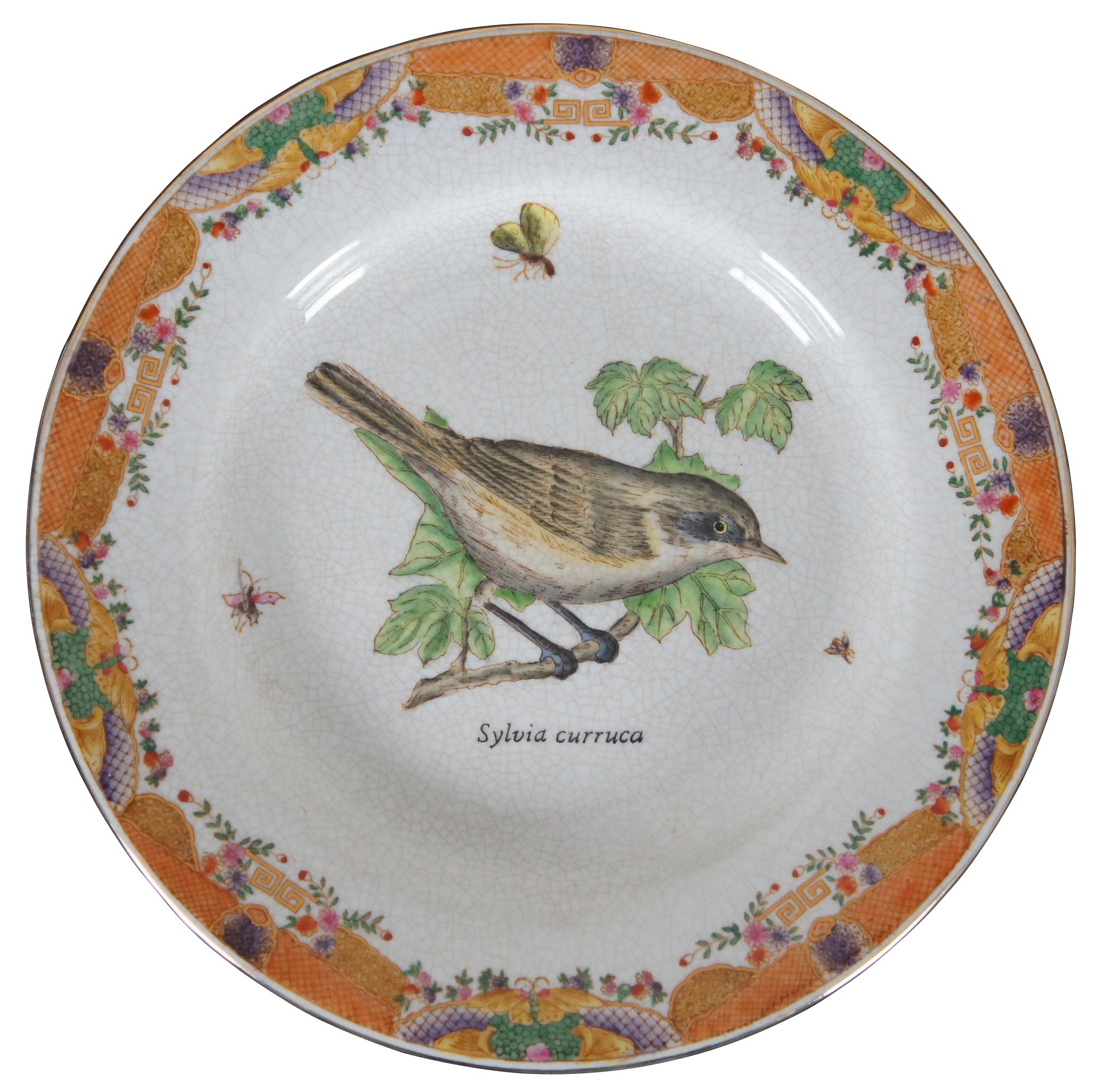 Set of eight decorative ceramic plates with different species of birds and their scientific names, in the style of Victorian illustrations, surrounded by an orange and purple Asian border and artificial crazing. “Wong Lee International Company of