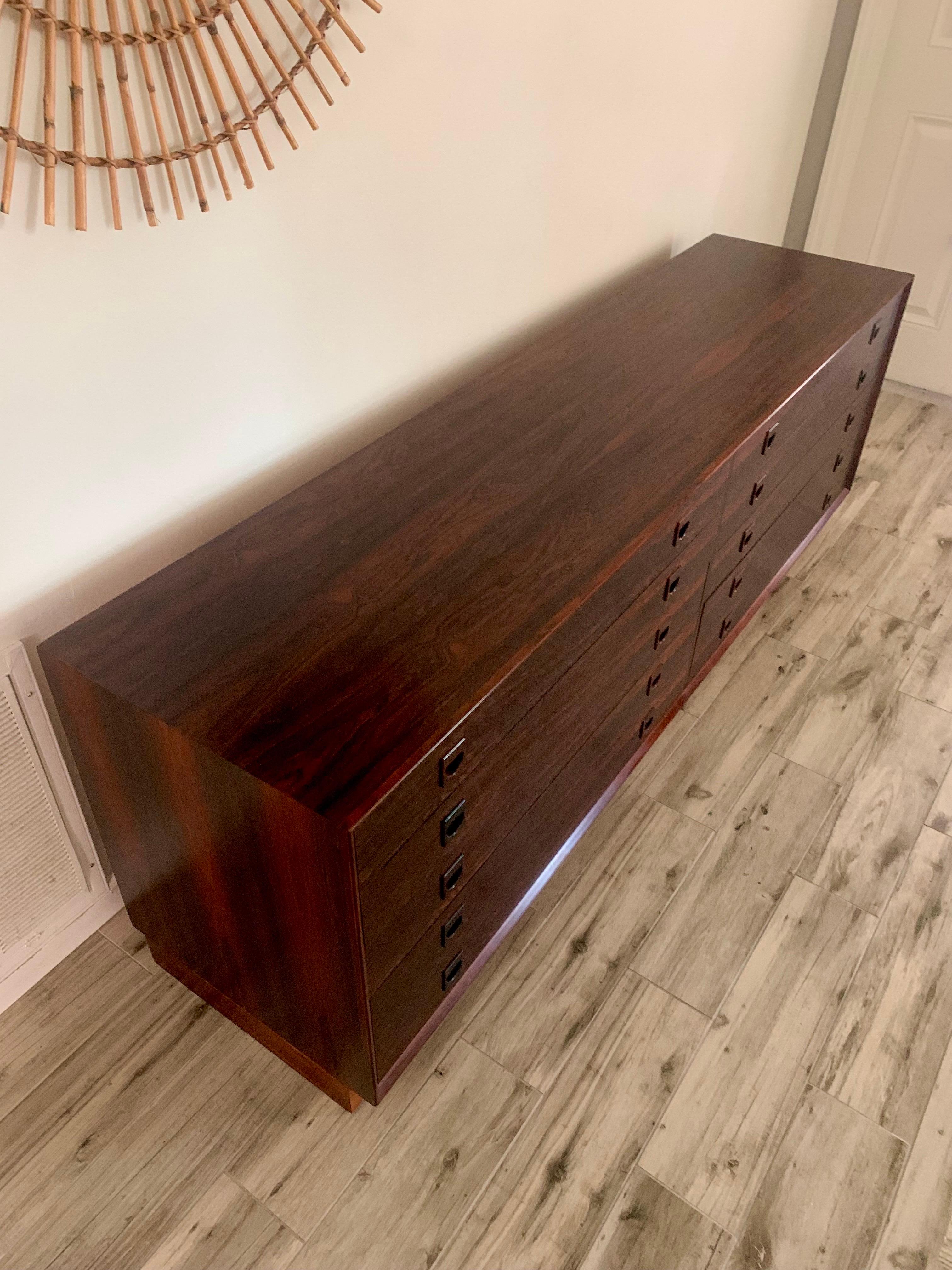 Beautiful rosewood dresser. Made in Denmark. Attributed to Arne Wahl Iversen. Circa 1960s. 

Very well made 8 drawer dresser. 6 smaller drawers and a double drawer on each side for the bottom row. Solid Hand carved fixed rosewood pulls. 

Book