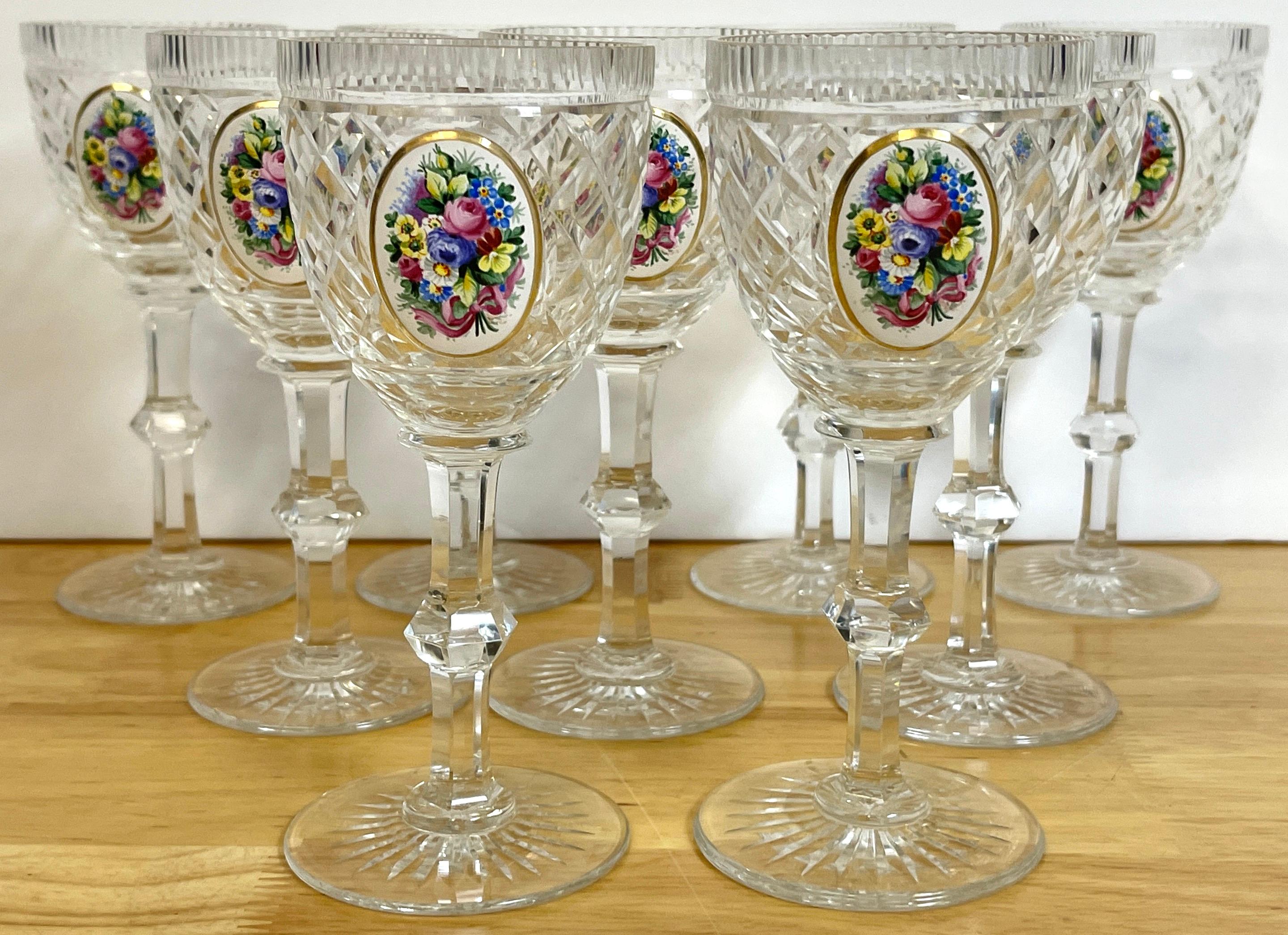 8 Exquisite Moser floral enameled cut to clear enamel glasses
Each one with a fine cross-hatched colorless crystal stems, with an oval enameled floral bouquet. 
Unmarked.
Measures: 6 height x 2.75.
 